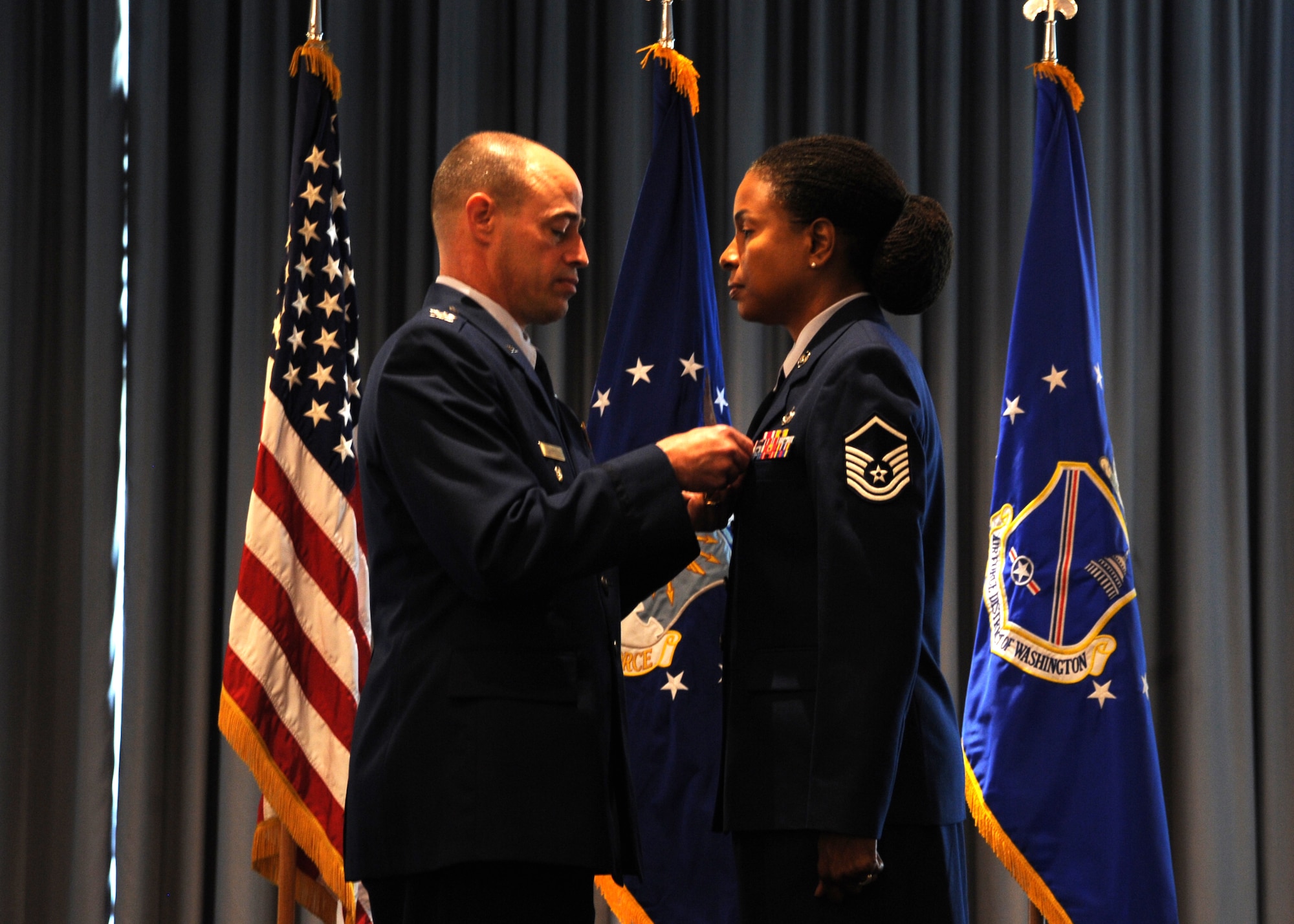Air Force District of Washington vice commander Col. Michael Gantt presents Master Sgt. Judith Hall with the Defense Meritorious Service Medal during the AFDW bi-montly retirement ceremony Aug. 27, 2013, at The Club on Joint Base Anacostia-Bolling, D.C. Hall served as an Administrative Control Program assistant for the 201st Mission Support Squadron, Air National Guard Readiness Center at Joint Base Andrews, Md. (U.S. Air Force photo by Tech. Sgt. Tammie Moore)