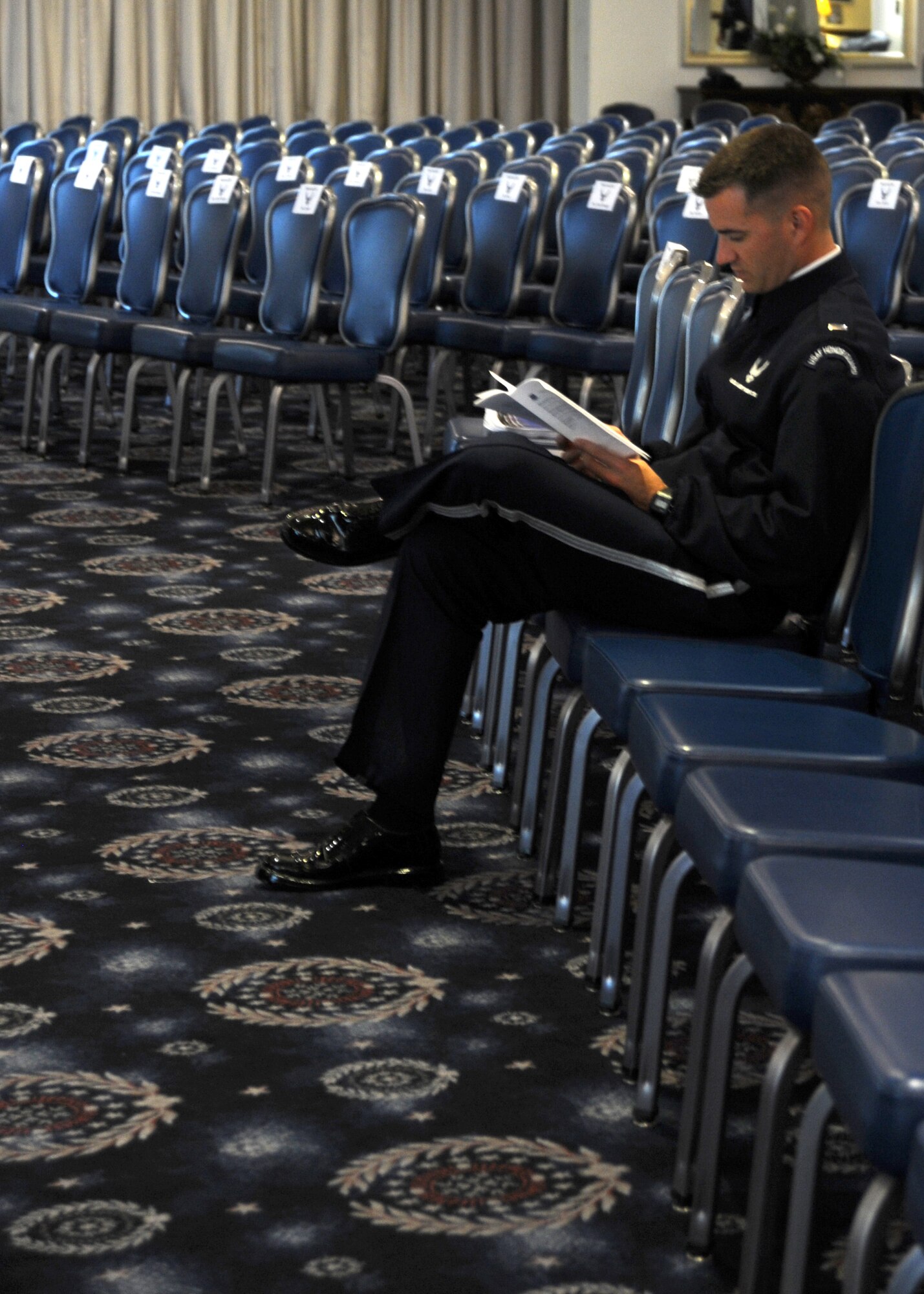 1st Lt. Paul Vernier, U.S. Air Force Honor Guard firing party flight commander, reviews the ceremony information for the Air Force District of Washington bi-montly retirement ceremony Aug. 27, 2013, at The Club on Joint Base Anacostia-Bolling, D.C. Airmen from the USAF Honor Guard serve as profters and present the colors during the retirement cermony.  (U.S. Air Force photo by Tech. Sgt. Tammie Moore)