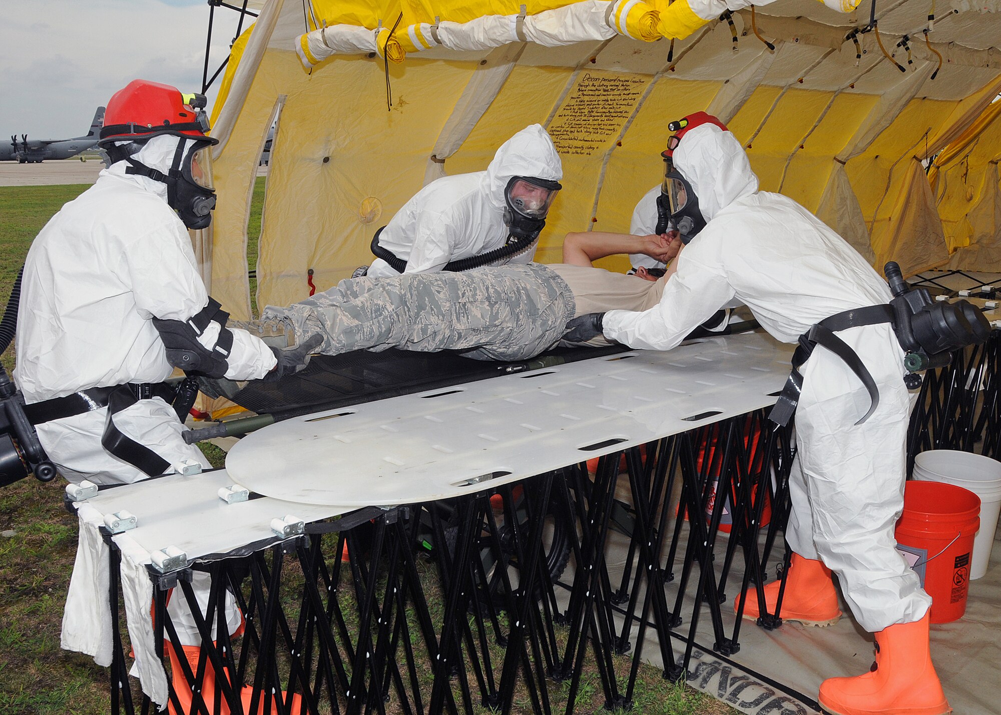 Members of the 143d Airlift Wing involved in the Region 1 Chemical, Biological, Radiological, Nuclear, High Yield Explosive Enhanced Response Force Package (CERFP) perform a training exercise to demonstrate the team's responsibilities and capabilities to potential new members and leadership. Colonel Arthur Floru (on stretcher),143d AW commander volunteered to play a victim for the exercise. The Region 1 CERFP is made up of members of the Air and Army National Guard from Maine, New Hampshire, and Rhode Island. National Guard Photo by Master Sgt Janeen Miller (RELEASED)