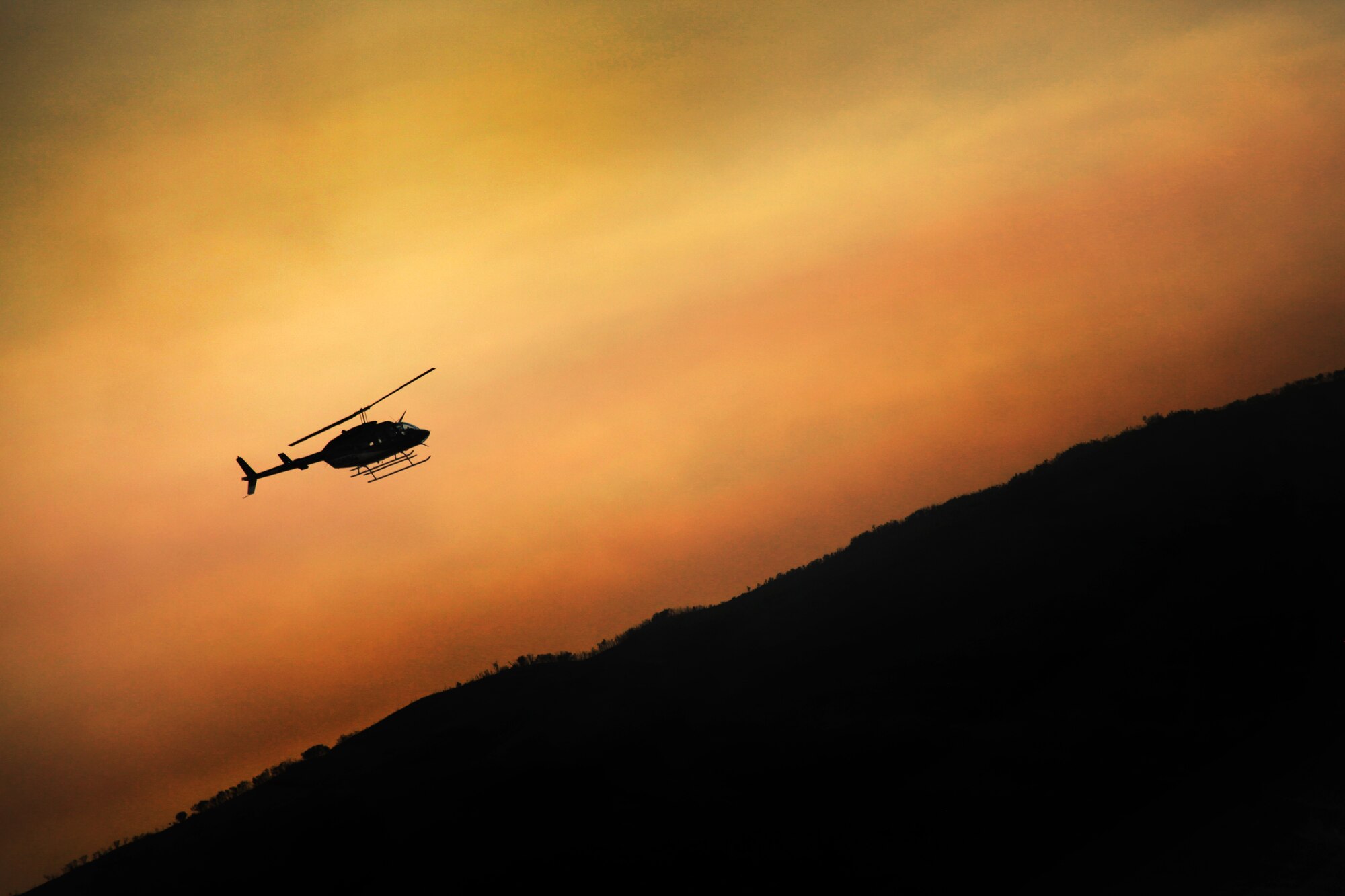 A helicopter views fire damage Aug. 14, 2013 near Rockport Reservoir in Warship, Utah.  Fire season has begun in the western states, making it all the more important to apply fire prevention and safety practices.  (U.S. Air Force photo/Senior Airman Jette Carr)