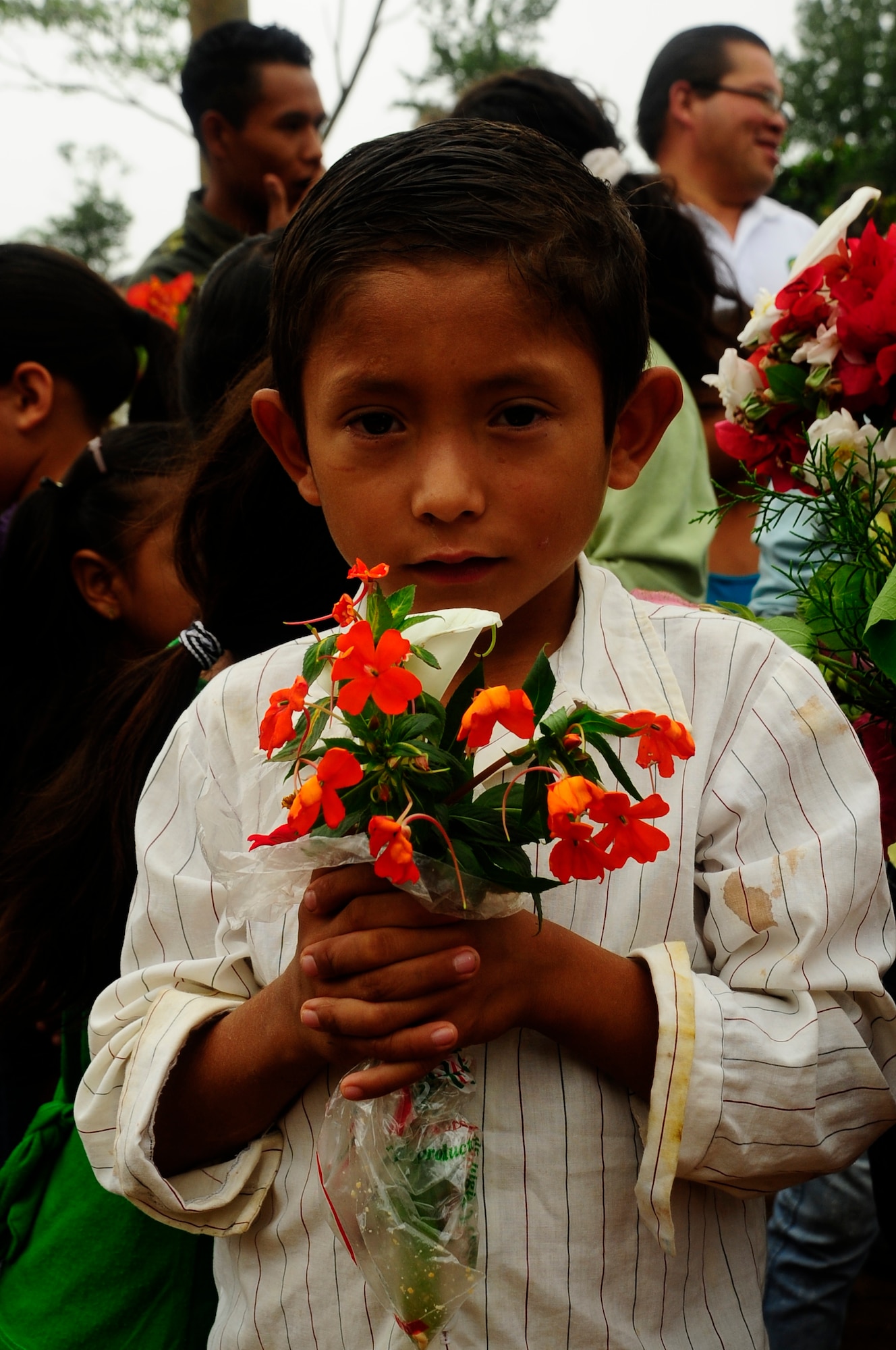 A young boy from the mountain village of Aldea Bella Vista poses with the flowers he’s going to give to a Joint Task Force-Bravo volunteer as a thank you for bringing food during the 50th Chapel Hike, Aug. 24, 2013. More than 80 Joint Task Force-Bravo personnel celebrated the Chapel’s 50th humanitarian hike, by trekking more than seven miles up a steep mountain road near Comayagua to food and additional supplies to more than 100 families. (Photograph by Staff Sgt. Jarrod Chavana) 