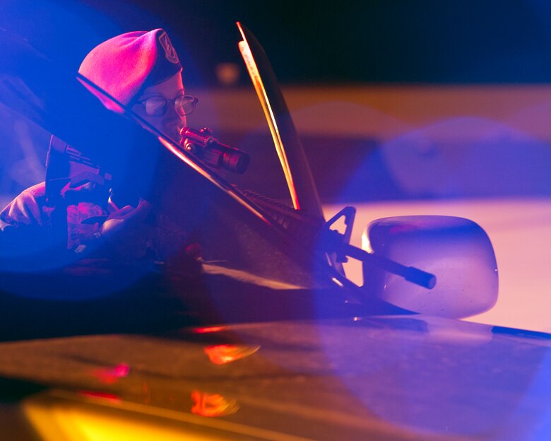 ALTUS AIR FORCE BASE, Okla. -- U.S. Air Force Senior Airman Laci Mendez, 97th Security Forces Squadron response force patrolman, looks over her weapon during a simulated security incident on the flightline Aug. 27. The 97th SFS is responsible for guarding the base 24 hours a day. They are one of the various squadrons that work around the clock to ensure mission success at Altus AFB. (U.S. Air Force photo by Senior Airman Kenneth W. Norman / Released)