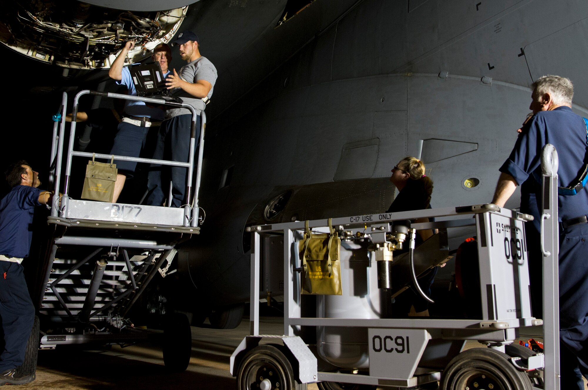 ALTUS AIR FORCE BASE, Okla. – Members of the 97th Maintenance Directorate, work to replace an Integrated Drive Generator on a U.S. Air Force C-17 Globemaster III during the night shift on the flightline, June 26. The 97th MX is one of the many squadrons that continues to work 24 hours a day to keep the mission at Altus AFB thriving. (U.S. Air Force photo by Kenneth W. Norman / Released)