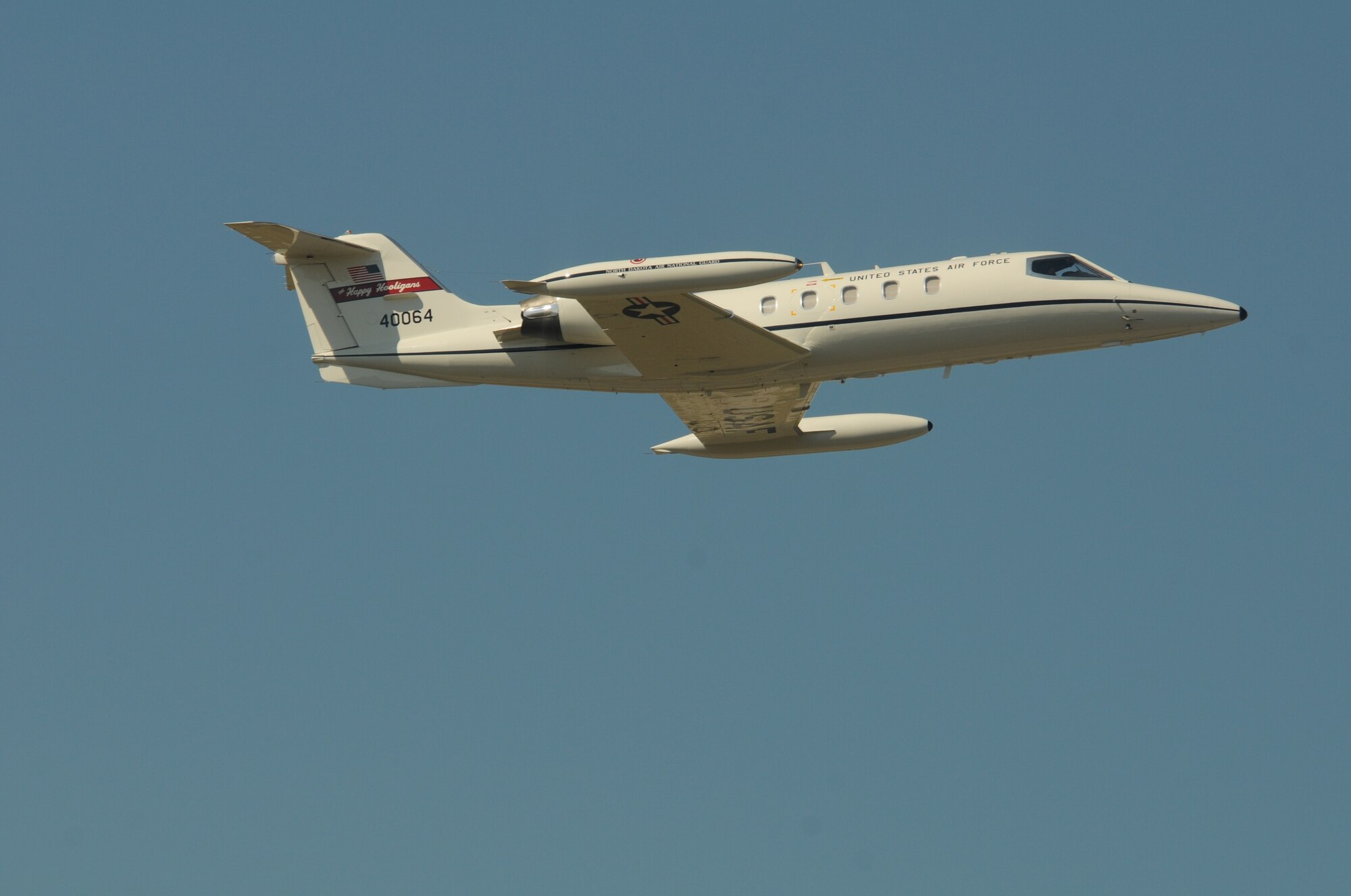 U.S. Air Force C-21 pilots Col. Brad Derrig, the 119th Wing vice-commander, and Col. Kent Olson, the 119th Wing commander, make one final pass in C-21 aircraft number 40064 during its’ final flight from the North Dakota Air National Guard Base, Fargo, N.D., Aug. 27, 2013. The aircraft is making its’ final flight for the unit before being retired at the National Museum of the U.S. Air Force, Dayton, Ohio, Aug. 28, 2013. This particular aircraft was the first C-21 Lear Jet built for the U.S. Air Force. The aircraft is the last to depart the unit during a mission conversion, leaving the unit without a manned flying mission for the first time since it began in 1947. It will be the only state in the United States without a manned flying mission. The unit has an outstanding flying record with over 174,000 hours without a class A mishap in manned aircraft. The 119th Wing is one of only two Air National Guard units to be selected for the U.S. Air Force Hughes Trophy, awarded to flying units, and the only Air National Guard unit to win the award twice. The unit also won the William Tell World-Wide fighter competition three times while flying fighters. (U.S. Air National Guard photo by SMSgt. David H. Lipp/Released)