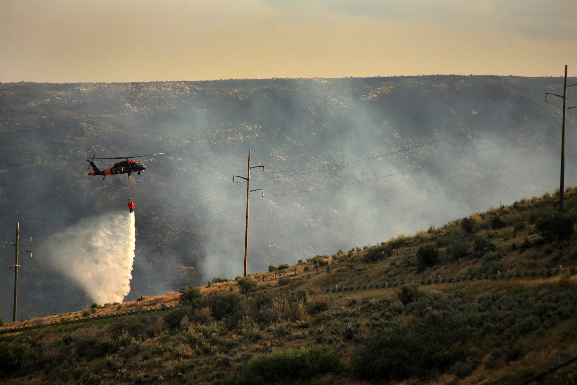 A helicopter helps with firefighting efforts Aug. 13, 2013 near Rockport Reservoir in Warship, Utah.  Fire season has begun in the western states, making it all the more important to apply fire prevention and safety practices.  (U.S. Air Force photo/Senior Airman Jette Carr)