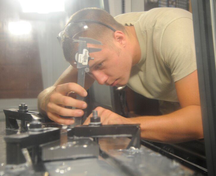 Airman 1st Class David Reid, 2nd Maintenance Squadron Fabrication flight aircraft metals technician, uses a dial caliper on an aircraft component on Barksdale Air Force Base, La., Aug. 28, 2013. The caliper is used to measure the depth of holes drilled into components to ensure parts fit when installed in an aircraft. (U.S. Air Force photo/Airman 1st Class Andrew Moua)