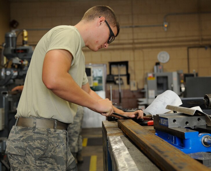 Airman 1st Class Jade Reynolds, 2nd Maintenance Squadron Fabrication flight aircraft metals technician, files down the edges on components for a sling on Barksdale Air Force La., Aug. 28, 2013. Reynolds filed down the edges to prevent personnel from injuring themselves when handling components. (U.S. Air Force photo/Airman 1st Class Andrew Moua)