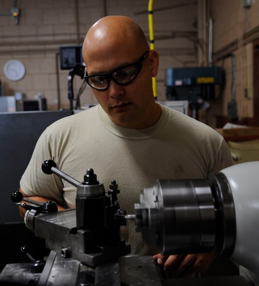 Staff Sgt. Ronnie Moses, 2nd Maintenance Squadron Fabrication flight metals technician, uses a lathe to create aircraft components on Barksdale Air Force Base, La., Aug. 28, 2013. Metals technology Airmen use the lathe to create components such as bushings, which are used to protect aircraft components from rubbing together and damaging the aircraft. (U.S. Air Force photo/Airman 1st Class Andrew Moua)