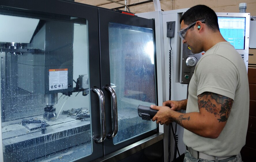 Senior Airman Tony Guinn, 2nd Maintenance Squadron Fabrication flight aircraft metals technician, uses an automatic fabricator on Barksdale Air Force Base, La., Aug. 28, 2013. Metals technology Airmen can automatically fabricate any part needed by inputting schematics into the machine for specific parts they need. (U.S. Air Force photo/Airman 1st Class Andrew Moua)