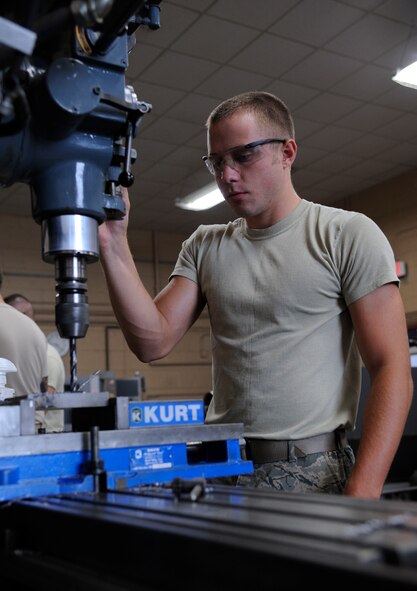Airman 1st Class David Reid, 2nd Maintenance Squadron Fabrication flight metals technician, drills holes into a caster plate on Barksdale Air Force Base, La., Aug. 28, 2013. The plate is used to attach wheels to stands and other equipment. (U.S. Air Force photo/Airman 1st Class Andrew Moua)