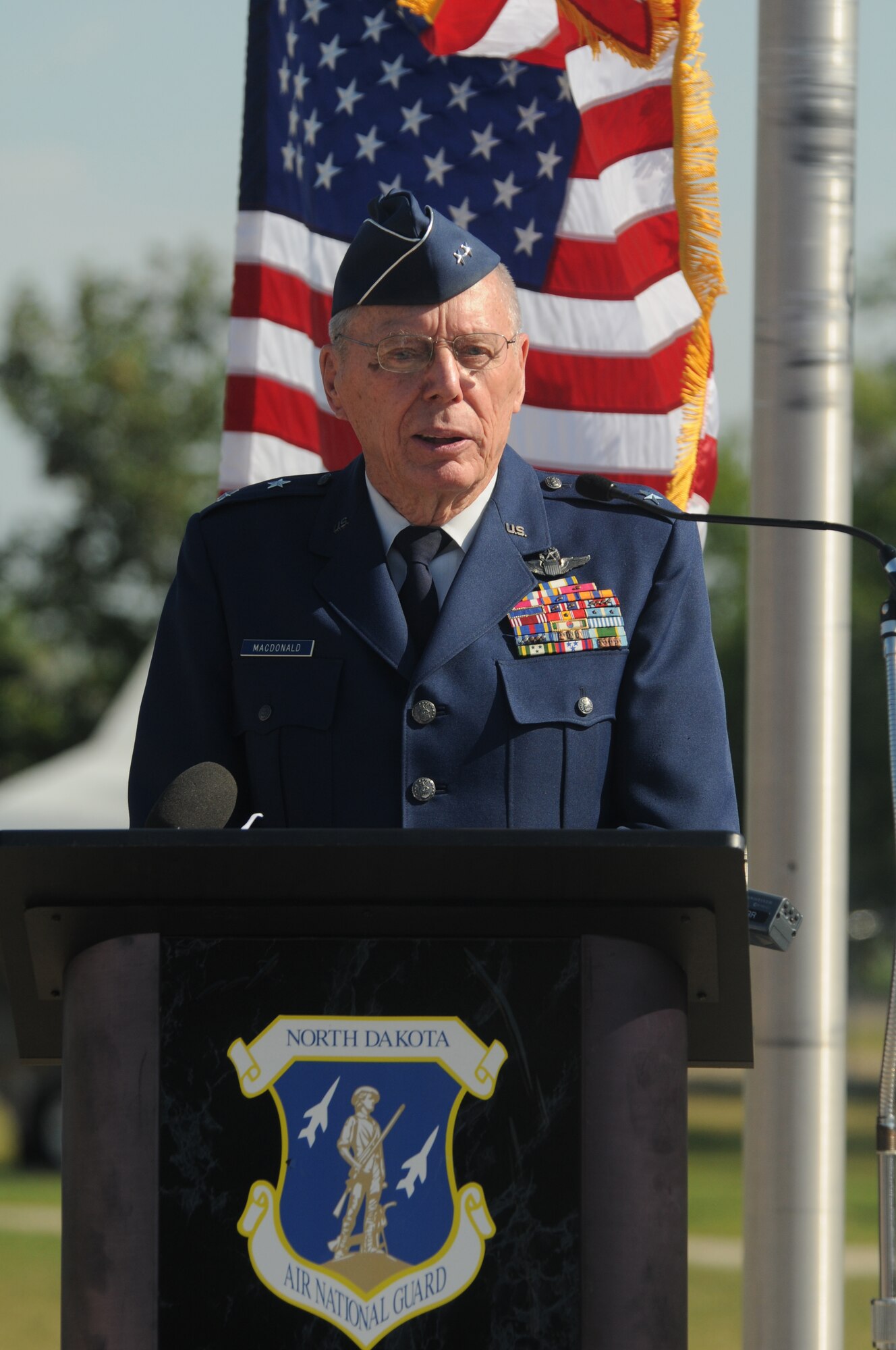U.S. Air Force retired Maj. Gen. Alexander P. Macdonald, former N. D. adjutant general, speaks to unit members of the 119th Wing and civilian media journalists at a press conference prior to the departure of the last C-21 aircraft number 40064 at the North Dakota Air National Guard Base, Fargo, N.D., Aug. 27, 2013. The aircraft is making its’ final flight for the unit before being retired at the National Museum of the U.S. Air Force, Dayton, Ohio, Aug. 28, 2013. This particular aircraft was the first C-21 Lear Jet built for the U.S. Air Force. The aircraft is the last to depart the unit during a mission conversion, leaving the unit without a manned flying mission for the first time since it began in 1947. It will be the only state in the United States without a manned flying mission. The unit has an outstanding flying record with over 174,000 hours without a class A mishap in manned aircraft. The 119th Wing is one of only two Air National Guard units to be selected for the U.S. Air Force Hughes Trophy, awarded to flying units, and the only Air National Guard unit to win the award twice. The unit also won the William Tell World-Wide fighter competition three times while flying fighters. (U.S. Air National Guard photo by SMSgt. David H. Lipp/Released)