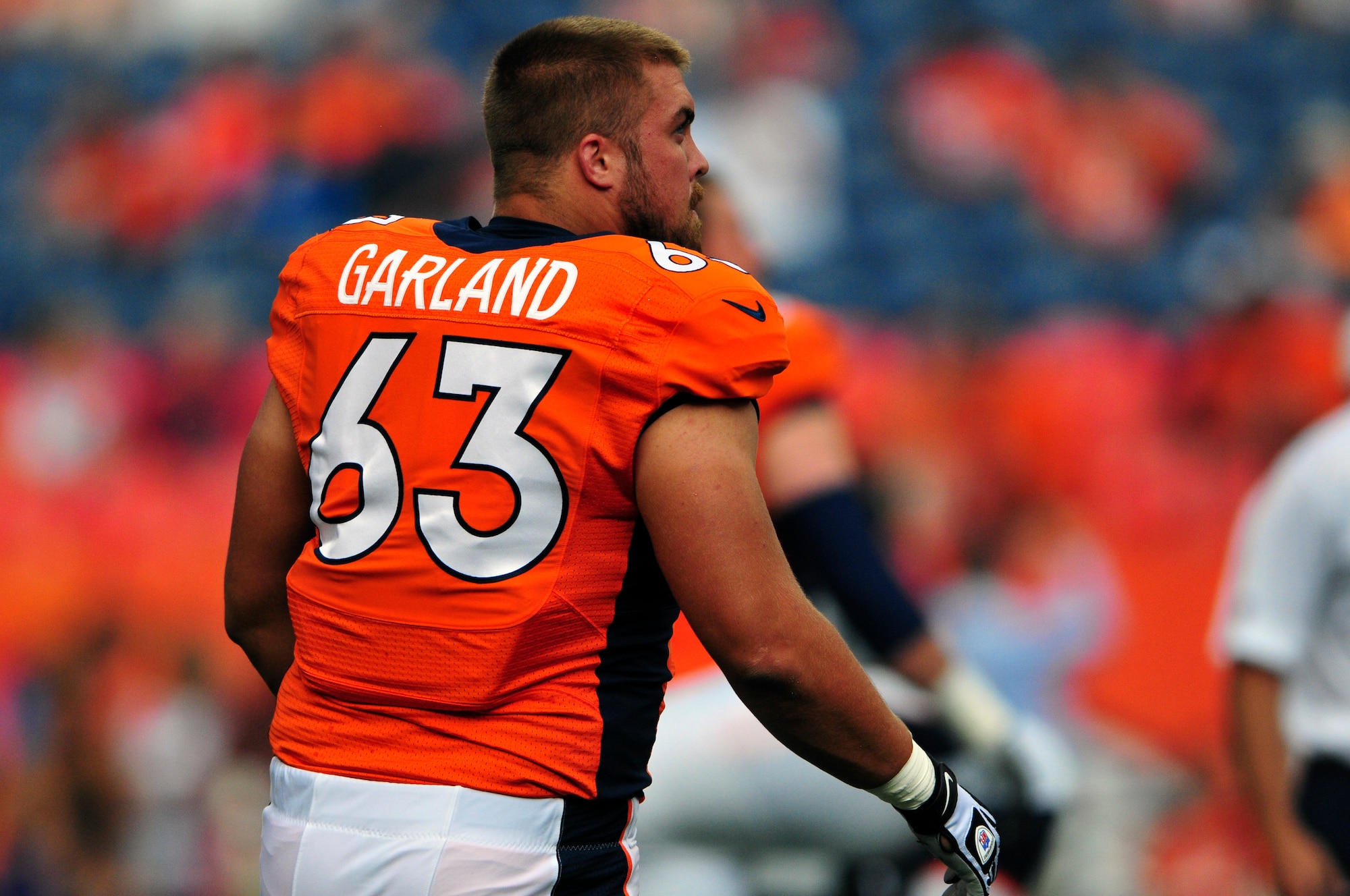 Air National Guard 1st Lt. Benjamin Garland (63), Denver Broncos Offensive Guard and 140th Wing Public Affairs Officer, stretches before a game at Sports Authority Field at Mile High Stadium, Denver, Colo. Aug 24, 2013. Garland, who originally entered the National Football League in 2010 after graduating from the U.S. Air Force Academy, was on the Bronco’s reserve/military list while fulfilling his active duty obligations in the Air Force. In 2012 Garland joined the Colorado Air National Guard and made the Broncos practice squad as a defensive lineman and is competing this season to make the 53 man final roster. (Air National Guard photo by Tech. Sgt. Wolfram M. Stumpf)