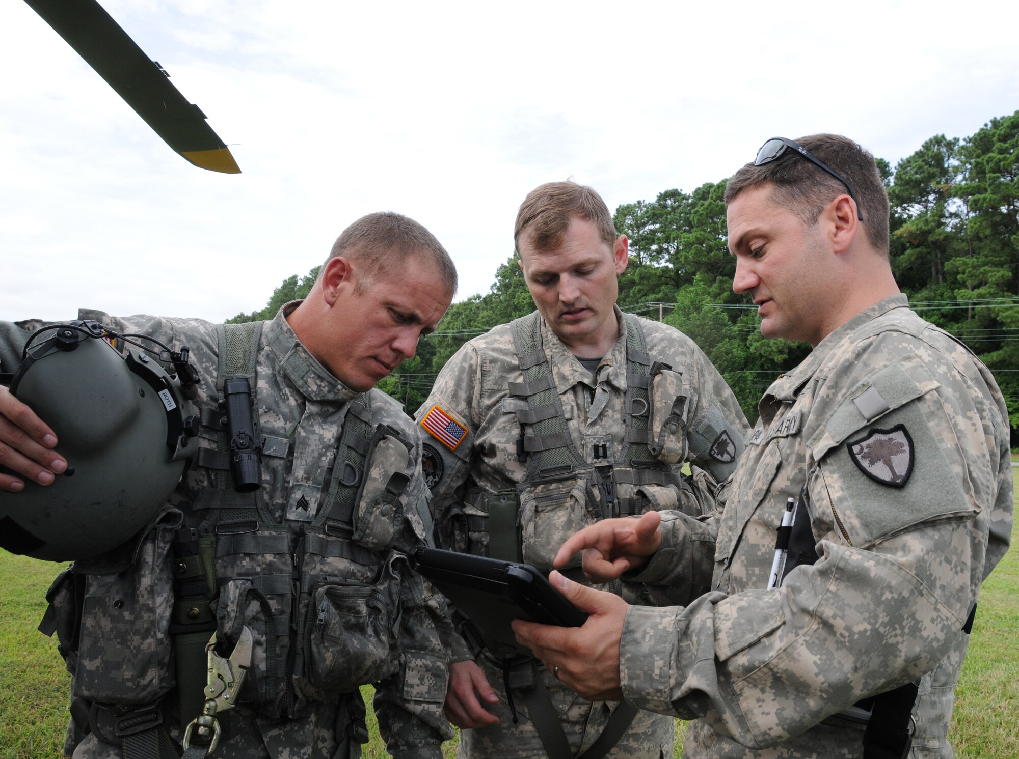 An aviation crew from the Virginia National Guard, Sandston-based Detachment 1, Company A, 2nd Battalion, 151st Aviation Regiment, discusses flight plans for their next mission in support of a domestic operations exercise 21 August.  Video feed from the helicopter is distributed to the 192nd Intelligence Squadron who process and distribute images to state agency customers.  The agencies make key decisions during natural disasters and emergencies based on what they see on the images. (U.S. Air National Guard photo by Master Sgt. Carlos Claudio).