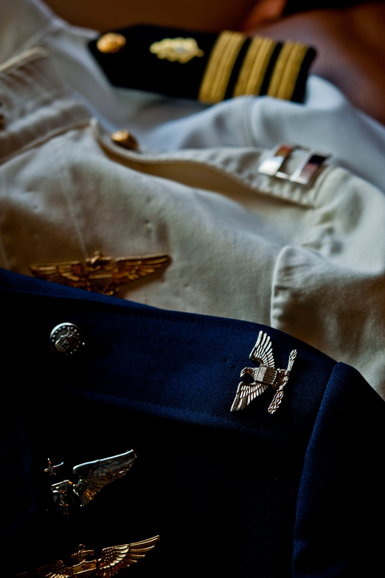 The uniforms U.S. Air Force retired Col. (Dr.) James Ruffer wore during his tenure in the U.S. military lie on top of each other at his home Aug. 16, 2013, in Summerlin, Nev. During his tours with three different branches of the military, Ruffer saw action in Vietnam, Panama and Operation Desert Storm. (U.S. Air Force photo by Senior Airman Daniel Hughes)