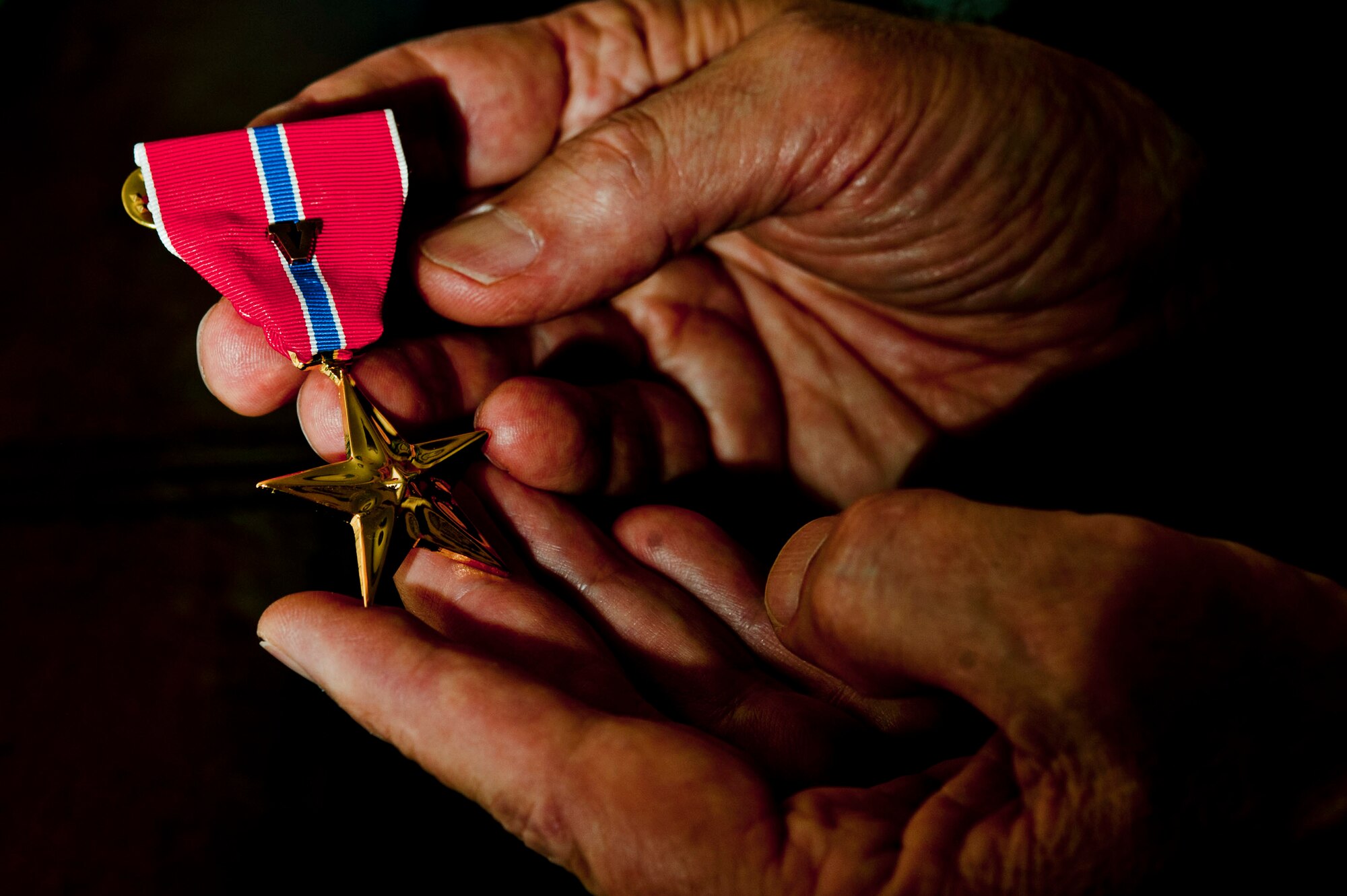U.S. Air Force retired Col. (Dr.) James Ruffer holds his Bronze Star with Valor at his home Aug. 16, 2013, in Summerlin, Nev. Ruffer received the Bronze Star with Valor more than 20 years after the events that took place which lead to his nomination for this medal. The Bronze Star with Valor was awarded in recognition of Ruffer’s efforts in Panama City, Panama, which lead to the Delta Force extraction of an imprisoned U.S. citizen. (U.S. Air Force photo by Senior Airman Daniel Hughes)
