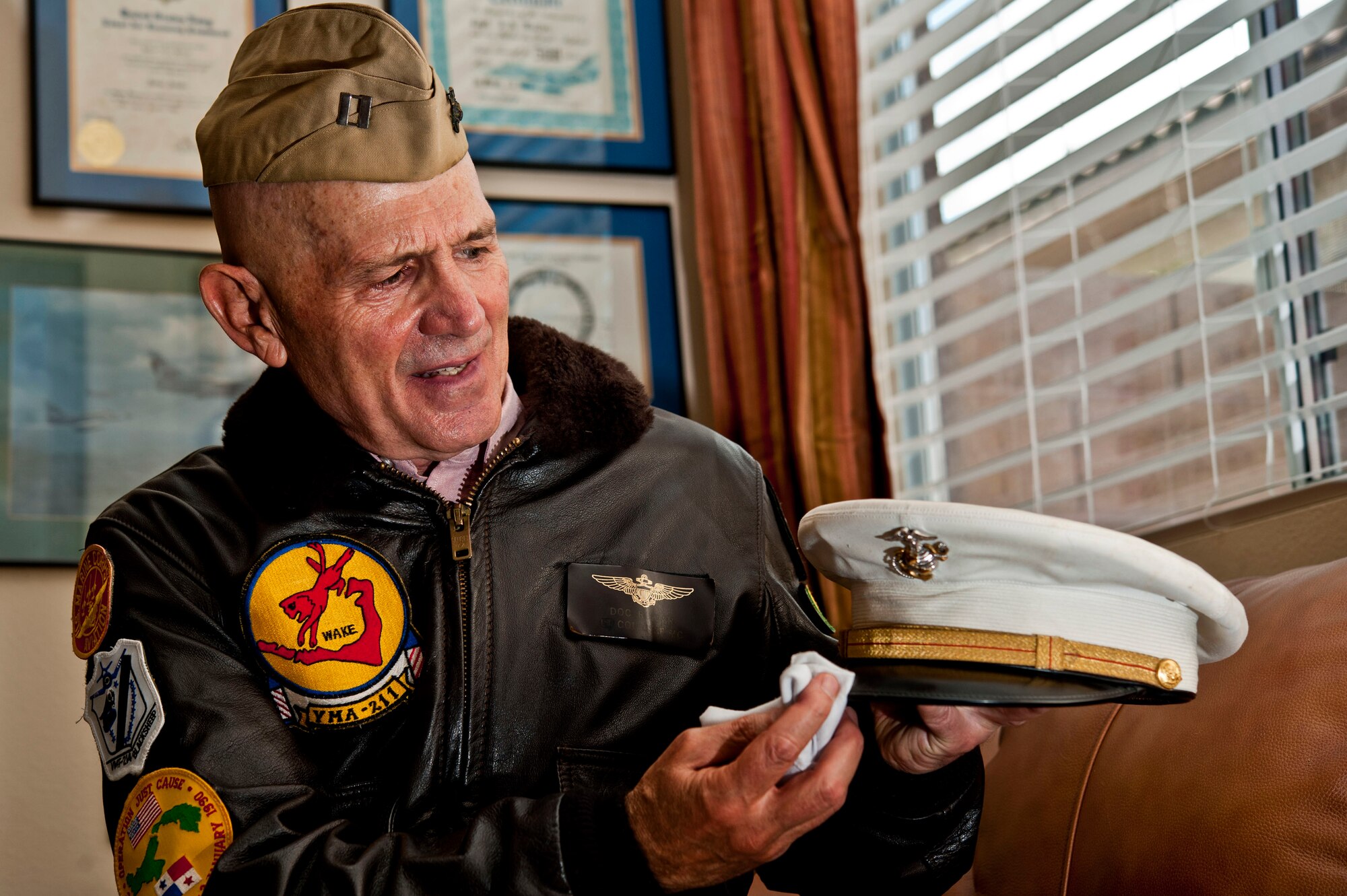U.S. Air Force retired Col. (Dr.) James Ruffer wipes off his U.S. Marine Corps cover at his home Aug. 16, 2013, in Summerlin, Nev. Ruffer served in the U.S. Air Force, U.S. Marines and the U.S. Navy throughout his 26 year military career. (U.S. Air Force photo by Senior Airman Daniel Hughes)