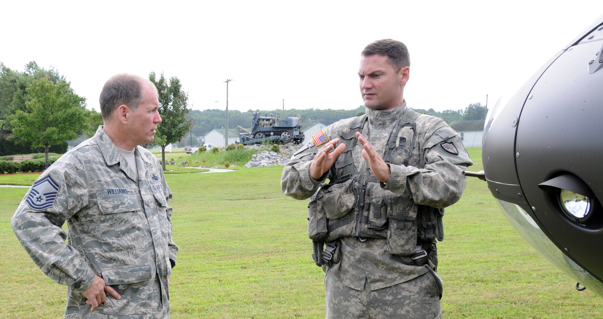 A 192nd Intelligence Squadron Superintendent (left) gets a post-flight briefing from an Army Guard copter pilot from the Sandston-based Detachment 1, Company A, 2nd Battalion, 151st Aviation Regiment, Virginia, 21 August.  Video feed from the UH-72 Lakota helicopter is distributed to the 192nd Intelligence Squadron who process and deliver images to state agency customers. (U.S. Air National Guard photo by Master Sgt. Carlos Claudio/Released).