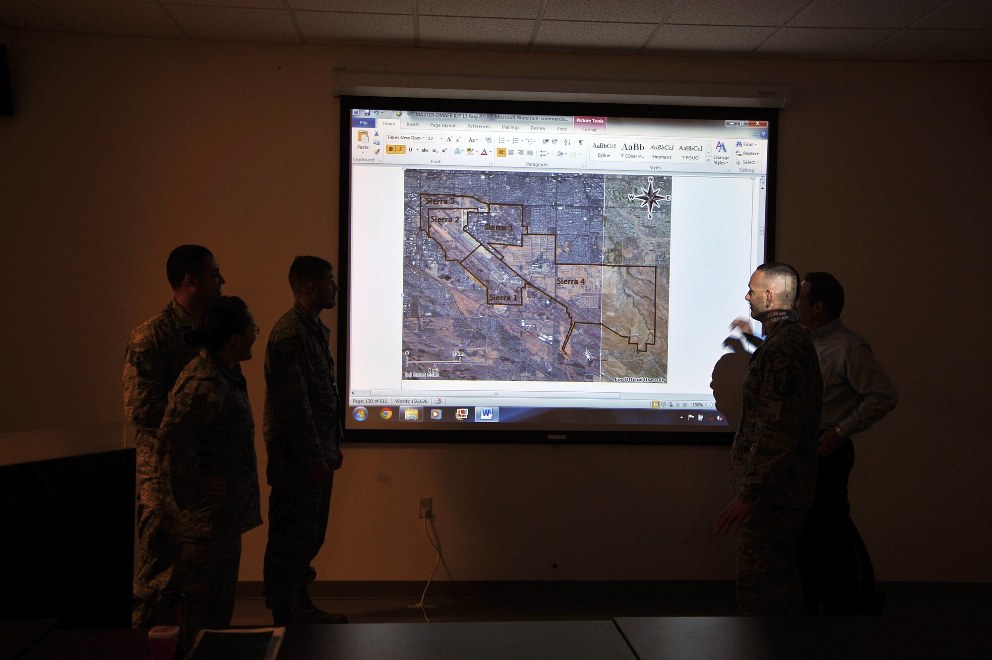 U.S. Air Force Master Sgt. Kurt Lugar, 355th Security Forces superintendent, looks over a map of Tucson with a team of subject matter experts, Ariz., August 14, 2013. Lugar and the SMEs are planning ways to defend base assets from possible threats.(U.S. Air Force photo by Airman 1st Class Josh Slavin/Released)