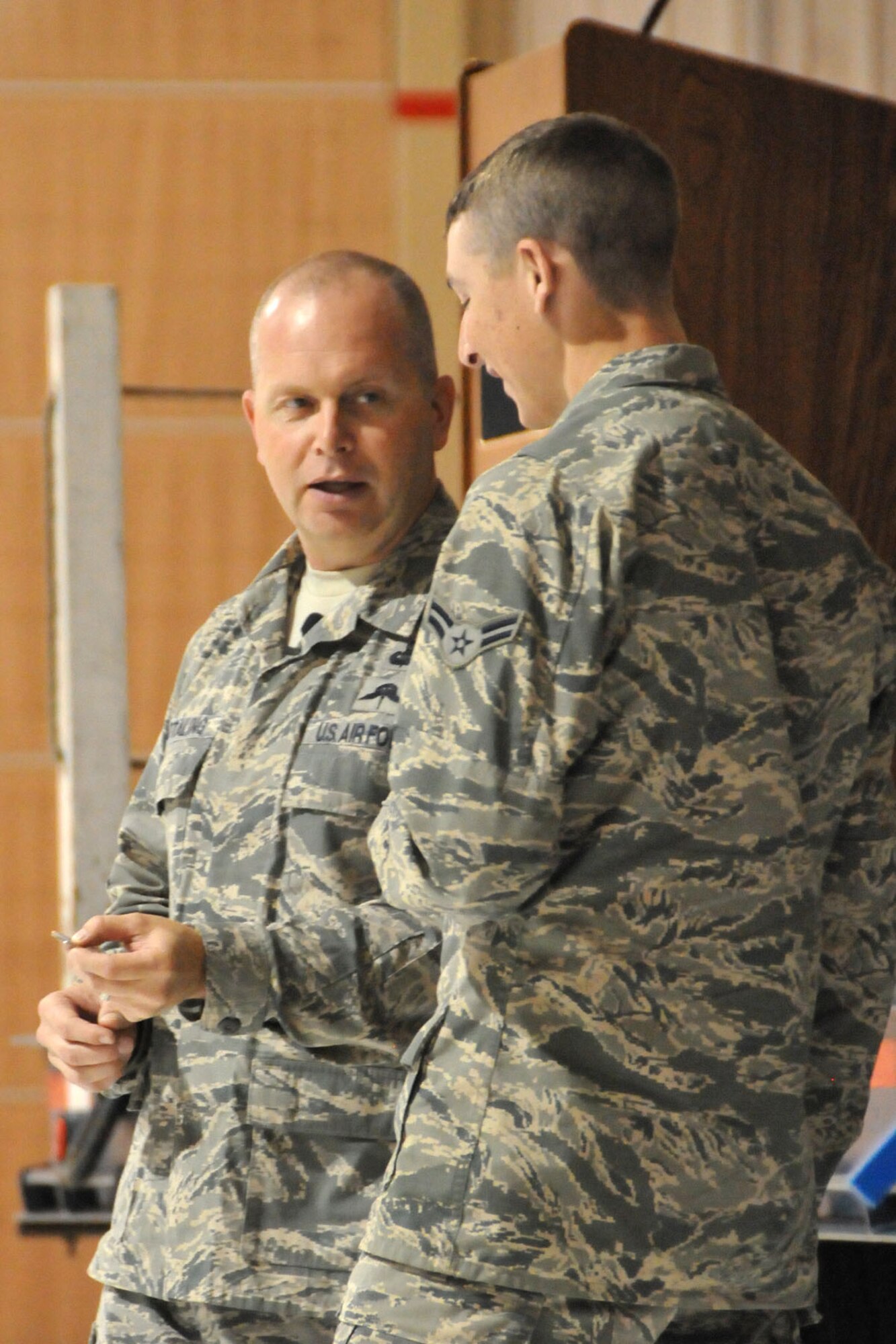 The Command Chief of the Air National Guard, Chief Master Sgt. James W. Hotaling, presents his chief’s coin to Airman 1st Class Vincent Peltzer on Aug. 10 during an All Call with members of the Montana Air National Guard’s 120th Fighter Wing. The All Call focused on renewing a commitment to the profession of arms, issues that impact the health of the force, and the importance of recognizing and embracing each unit member’s accomplishments. (U.S. Air National Guard photo/Senior Master Sgt. Eric Peterson)
