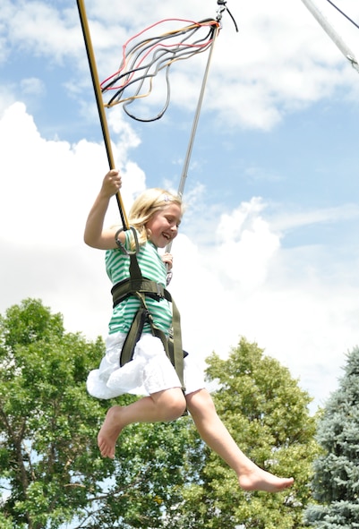 Aneka catches some air on the bungee trampoline during the 302nd Airlift Wing’s family day Aug. 3 at Peterson Air Force base. Family day is an annual event for members of the 302nd AW to bring their relatives out for a day of barbeque, games and relaxation. (U.S. Air Force photo/Master Sgt. Daniel Butterfield)