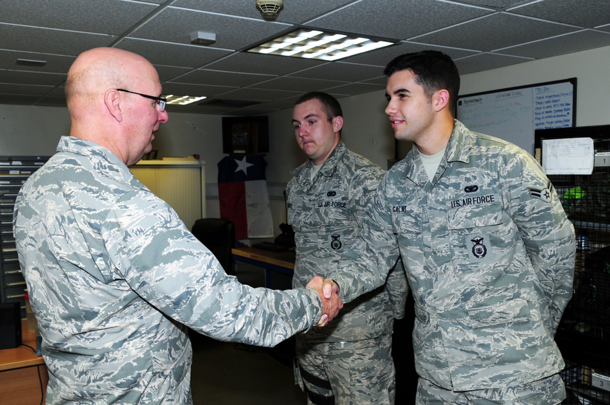 U.S. Air Force Airman 1st Class Ryan Galat, right, 100th Security Forces Squadron armorer from Dallas, Texas, and U.S. Air Force Senior Airman Mickey Grubbs, 100th SFS armorer from Gilmer, Texas, meet U.S. Air Force Col. Mark Eichin, Headquarters U.S. Air Forces in Europe Security Forces chief, from Ramstein Air Base, Germany, during a visit of 100th SFS facilities Aug. 27, 2013, on RAF Mildenhall, England. The "Top Cop" visited 100th SFS facilities and guard mounts, met with Airmen and chatted briefly with them about 100th SFS issues. Eichin said he first came to RAF Mildenhall 23 years ago as a lieutenant, arriving here on the rotator after being assigned to RAF Bentwaters.  (U.S. Air Force photo by Karen Abeyasekere/Released)