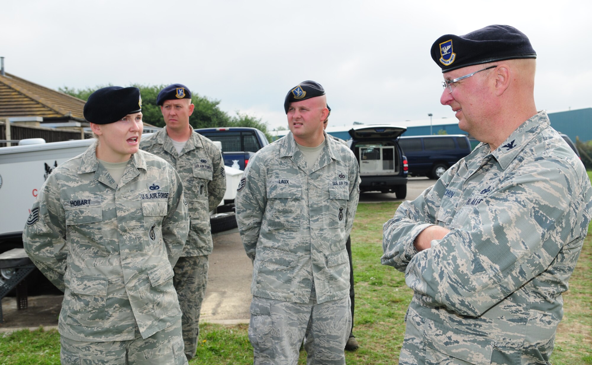 U.S. Air Force Staff Sgt. Hannah Hobart, left, 100th Security Forces Squadron Military Working Dog section NCO in charge from Aurora, Ind., speaks with U.S. Air Force Col. Mark Eichin, right, Headquarters U.S. Air Forces in Europe Security Forces chief, from Ramstein Air Base, Germany, about the future of MWDs in the Air Force Aug. 27, 2013, at the MWD facility on RAF Mildenhall, England. Eichin, the "Top Cop," along with Chief Master Sgt. George Barkman, HQ USAFE Security Forces manager, toured 100th SFS facilities as part of a site visit in the United Kingdom. Eichin and Barkman spoke with 100th SFS Airmen and coined several they met along the way. The "Top Cop" has a personal interest in the MWD program as he adopted the second-ever MWD in the Air Force. (U.S. Air Force photo by Karen Abeyasekere/Released)
