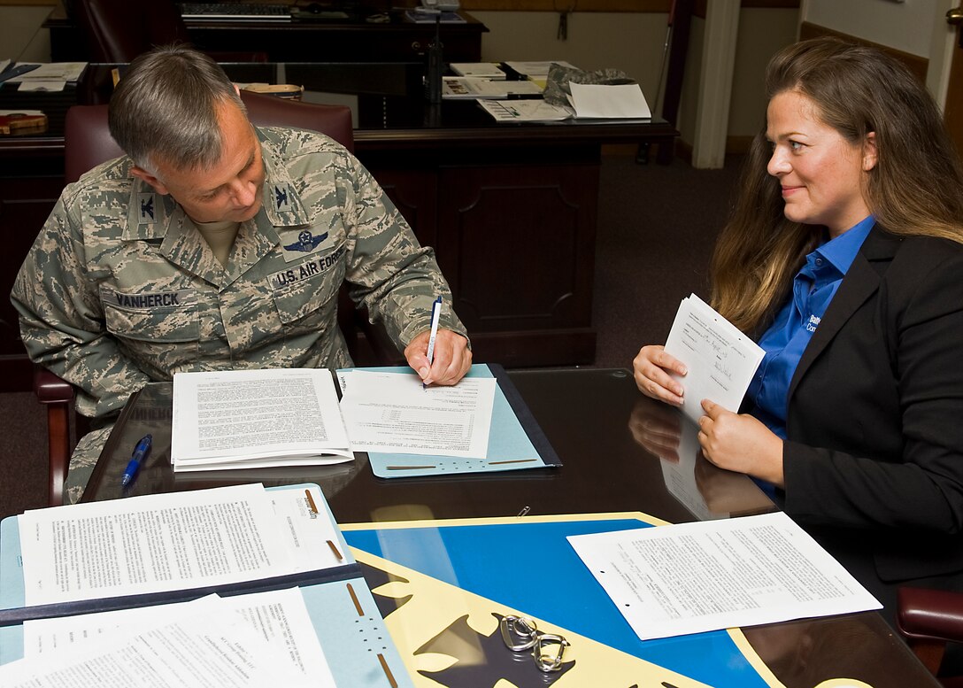 U.S. Air Force Col. Glen VanHerck, 7th Bomb Wing commander, signs Dyess' first official privatized housing lease Aug. 27, 2013, at Dyess Air Force Base, Texas.  As part of Dyess’ housing privatization transition, Balfour Beatty Communities will be performing unit enhancements and construction of multiple community enhancements across Dyess’ on-base housing. (U.S. Air Force photo by Senior Airman Peter Thompson/Released)
