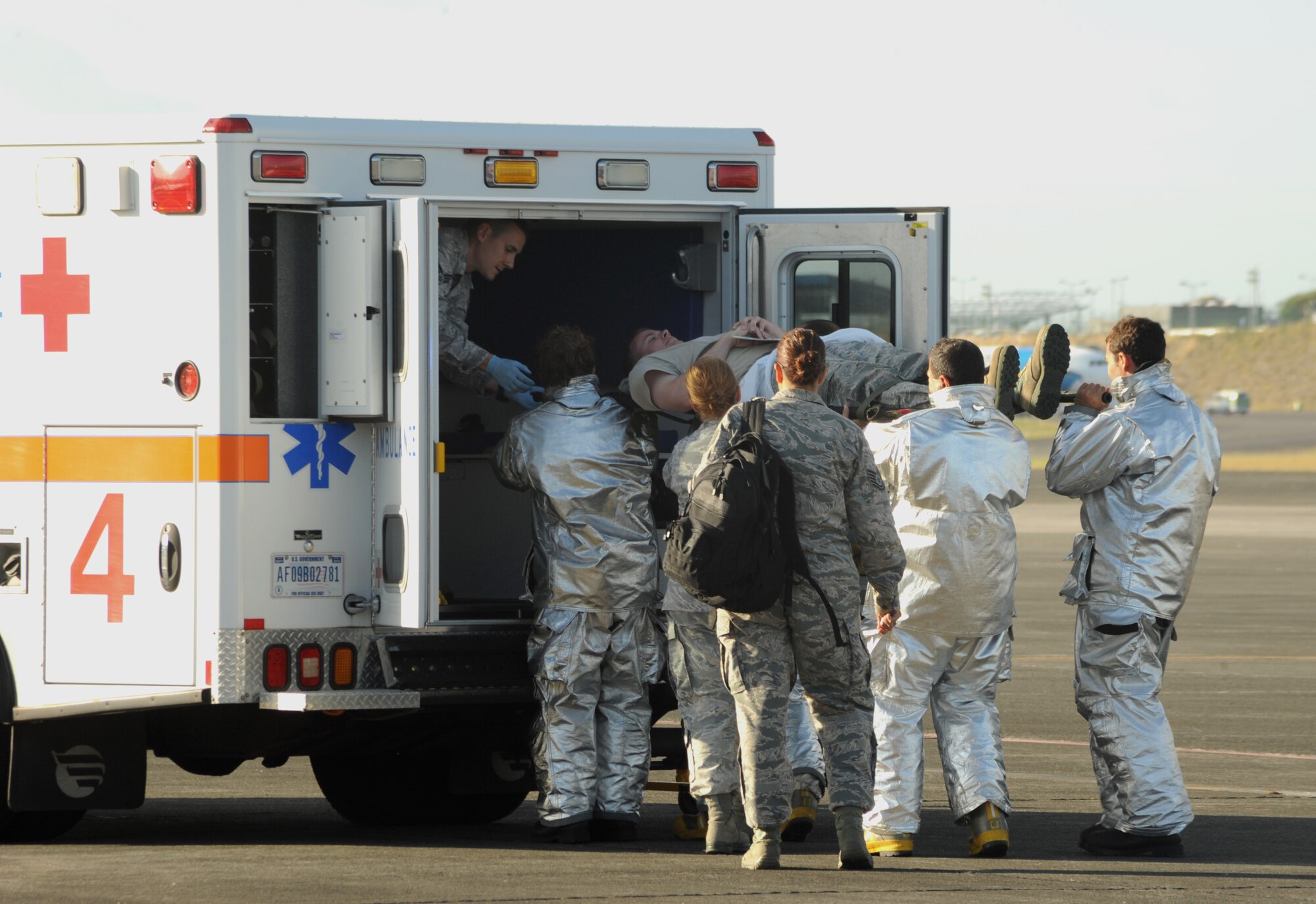 Airmen from the 65th Air Base Wing and Portuguese Air Force load a mock victim into an ambulance during a major accident response exercise Aug. 23, 2013, at Lajes Field, Azores.  The exercise tested the ability of the U.S. and Portuguese Air Force to respond jointly in the event of an aircraft accident.   (U.S. Air Force photo by Guido Melo/Released)