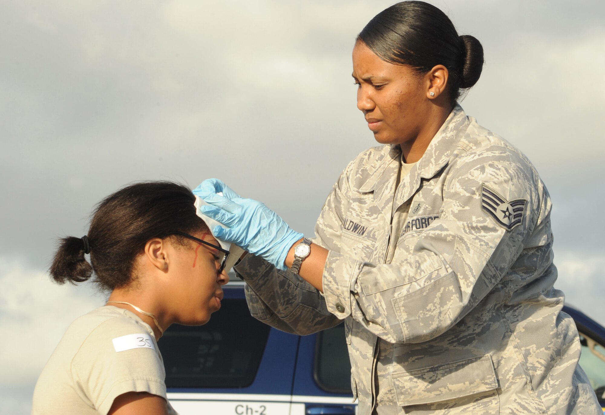 U.S. Air Force Staff Sgt. Yvette Baldwin, 65th Medical Operations Squadron medical technician, gives first aid to a mock victim during a major accident response exercise Aug. 23, 2013, at Lajes Field, Azores.  The exercise tested the ability of the U.S. and Portuguese Air Force to respond jointly in the event of an aircraft accident.   (U.S. Air Force photo by Guido Melo/Released)