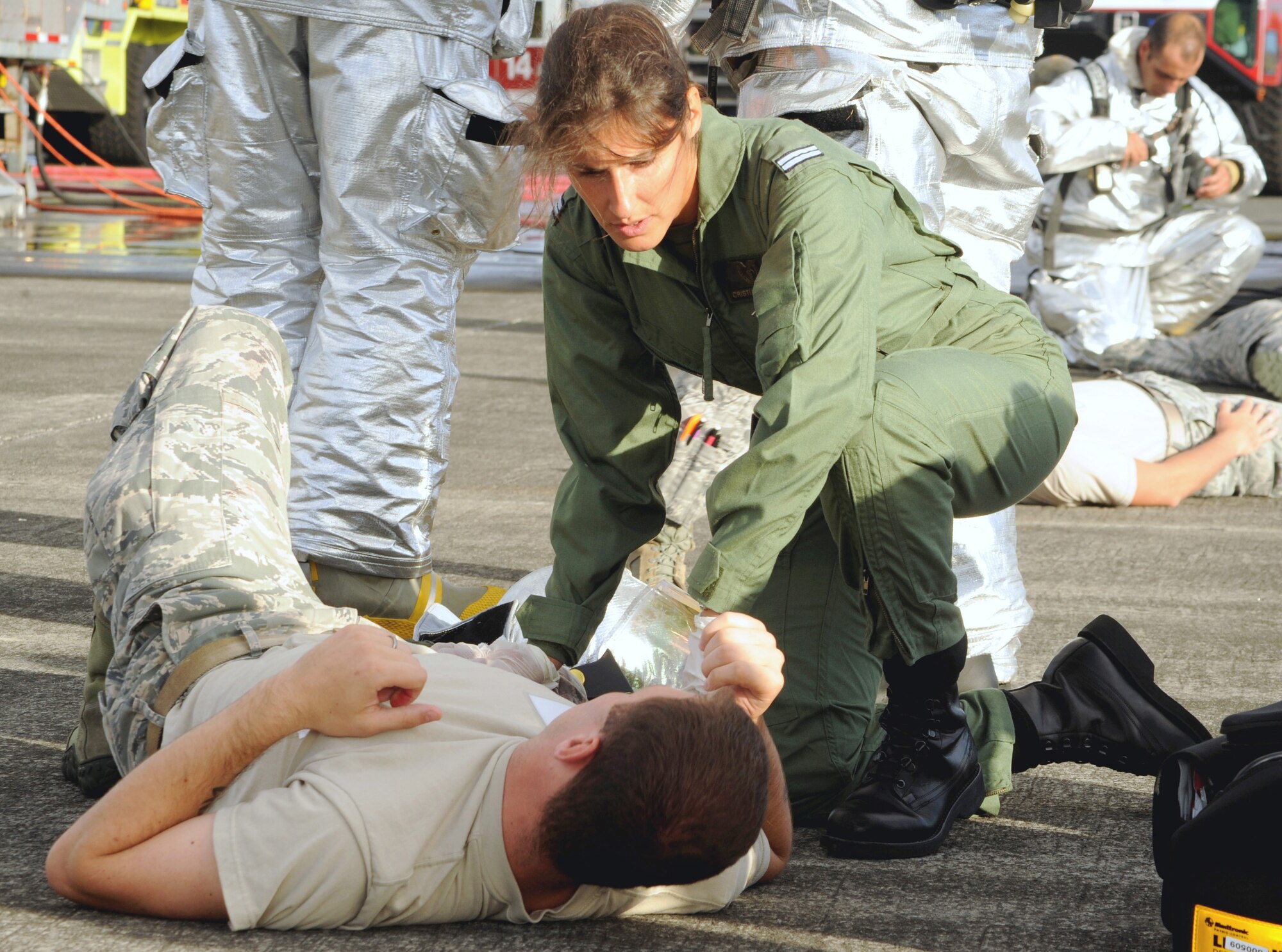 Portuguese Air Force 1st Lt. Cristina Silva, Portuguese Air Force physician, give first aid to a mock victim during a major accident response exercise Aug. 23, 2013, at Lajes Field, Azores.  The exercise tested the ability of the U.S. and Portuguese Air Force to respond jointly in the event of an aircraft accident.   (U.S. Air Force photo by Guido Melo/Released)