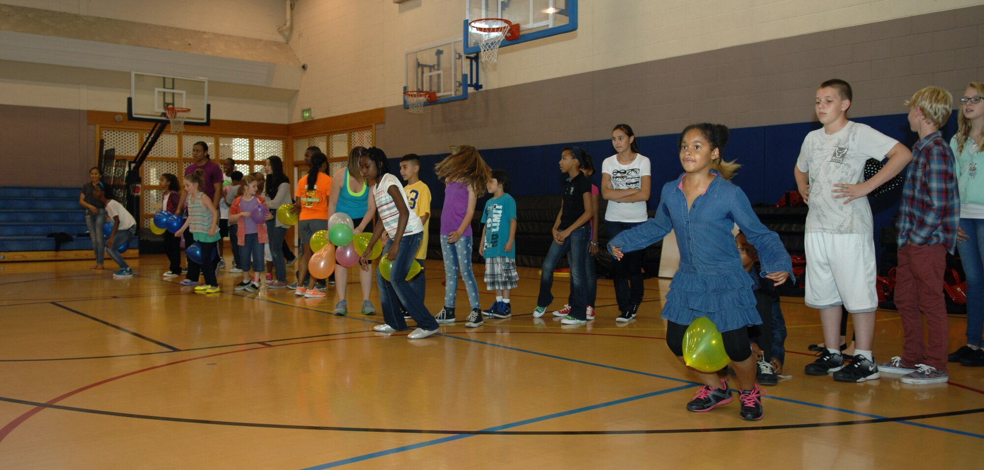 Team Mildenhall children participate in a balloon race Aug. 26, 2013, as part of a women’s equality celebration at the youth center on RAF Mildenhall, England.  Children participated in numerous activities while learning facts about women’s equality. The goal of the day was to educate children about the differences in women’s rights through history while having fun. (U.S. Air Force photo by Airman 1st Class Dillon Johnston/Released)