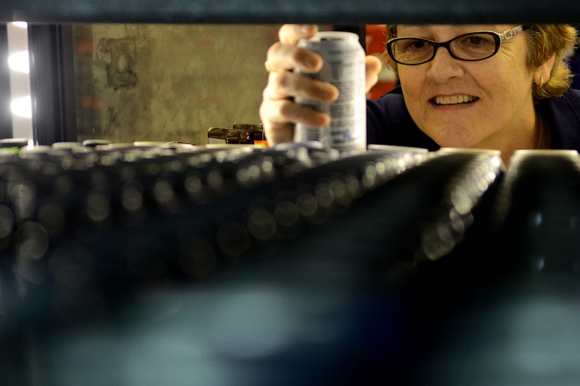 Susan Sisneros, Exchange employee, restocks energy drinks Aug. 26, 2013 at Fort Eustis, Va. About 44.8 percent of deployed Service members have at least one energy drink a day. (U.S. Air Force photo by Airman 1st Class Austin Harvill/Released)