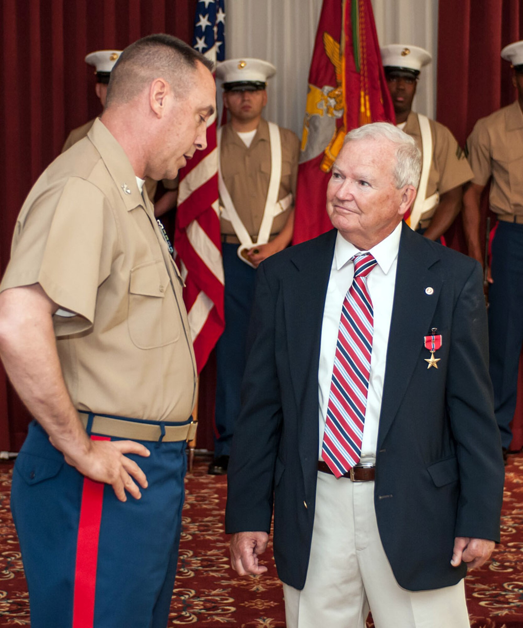 HANSCOM AIR FORCE BASE, Mass. – Retired U.S. Marine Corps Staff Sgt. David M. Nugent speaks to Col. Russell E. Smith, 25th Marine Regiment commander, after being presented the Bronze Star with the Combat Distinguishing Device for bravery during the Vietnam War in 1967. During a ceremony at the Minuteman Commons Aug. 26, Nugent was recognized for heroic actions when an enemy grenade landed near him in his fighting position and while attempting to remove it, the grenade detonated, wounding him and three others. (U.S. Air Force photo by Rick Berry)