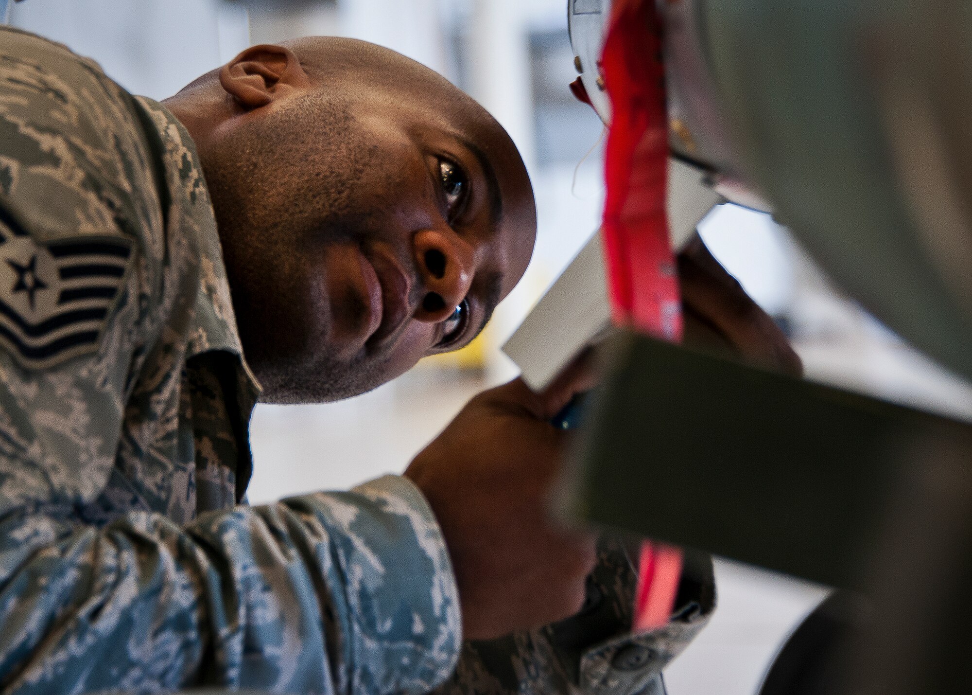 Tech. Sgt. Jamal Smith, of the 33rd Maintenance Group, secures a warhead to the front of a guided-bomb-unit 12 before it’s attached to an F-35A Lightning II Aug. 27 at Eglin Air Force Base, Fla.  This marked the first time Airmen have loaded weapons onto the new joint strike fighter here.  Each step and procedure was analyzed to ensure it was correct or needed to be changed.  The weapons load procedures perfected by the MXG Airmen will be taught to maintenance students in the future.  (U.S. Air Force photo/Samuel King Jr.)