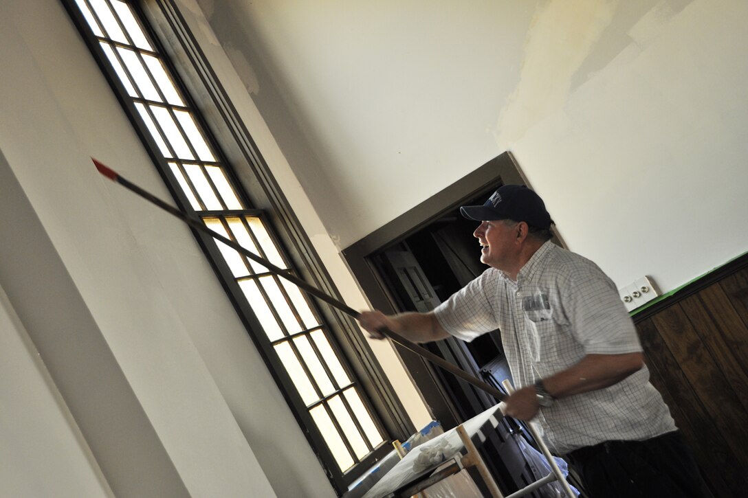 Chief Master Sgt. David Curtis (Ret.), former 94th Airlift Wing suerintendent and member of the Dobbins Chiefs Group, paints wals of the former Dobbins Chapel during Project B.Y.O.B. (Bring Your Own Brush) Aug. 24. The chapel, now located at the Clay National Guard Center in Marietta, Ga., has been going through renovation since its move from Dobbins March 17. (U.S. Air force photo/James Branch)