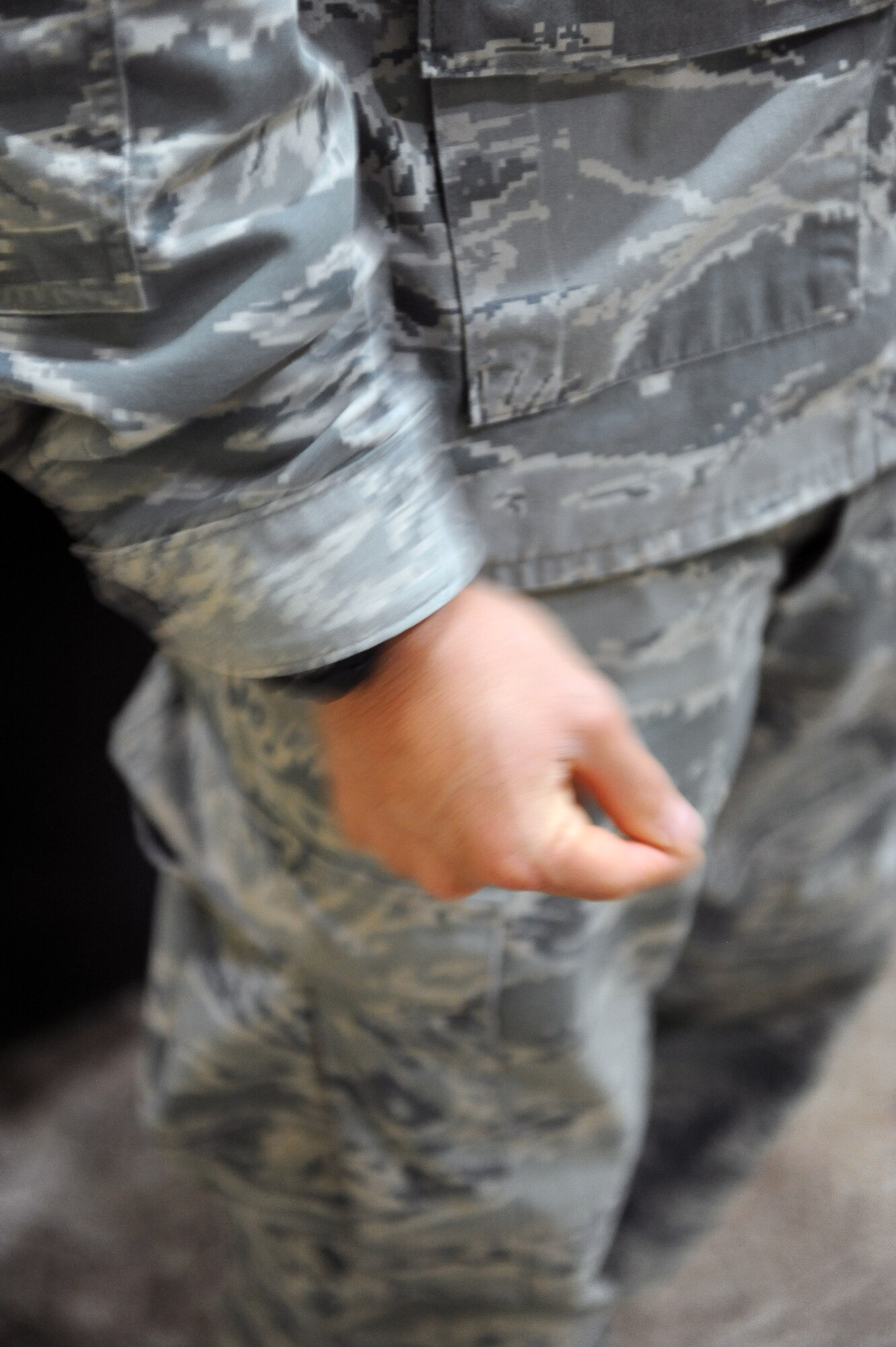 Senior Airman Christopher Hernandez, an aiguillette wearing honor guard member, snaps the cadence to help keep the new members on beat during honor guard practice at an undisclosed location in Southwest Asia Aug. 27, 2013.  The 386th Air Expeditionary Wing Honor Guard currently has about 30 members, 12 of whom are aiguillette wearers.  Members who wear the aiguillette are experienced honor guard members working toward the honor guard brassard.  Aiguillette wearers are used as trainers for the newer members of the team.  (U.S. Air Force photo by Master Sgt. Marelise Wood)