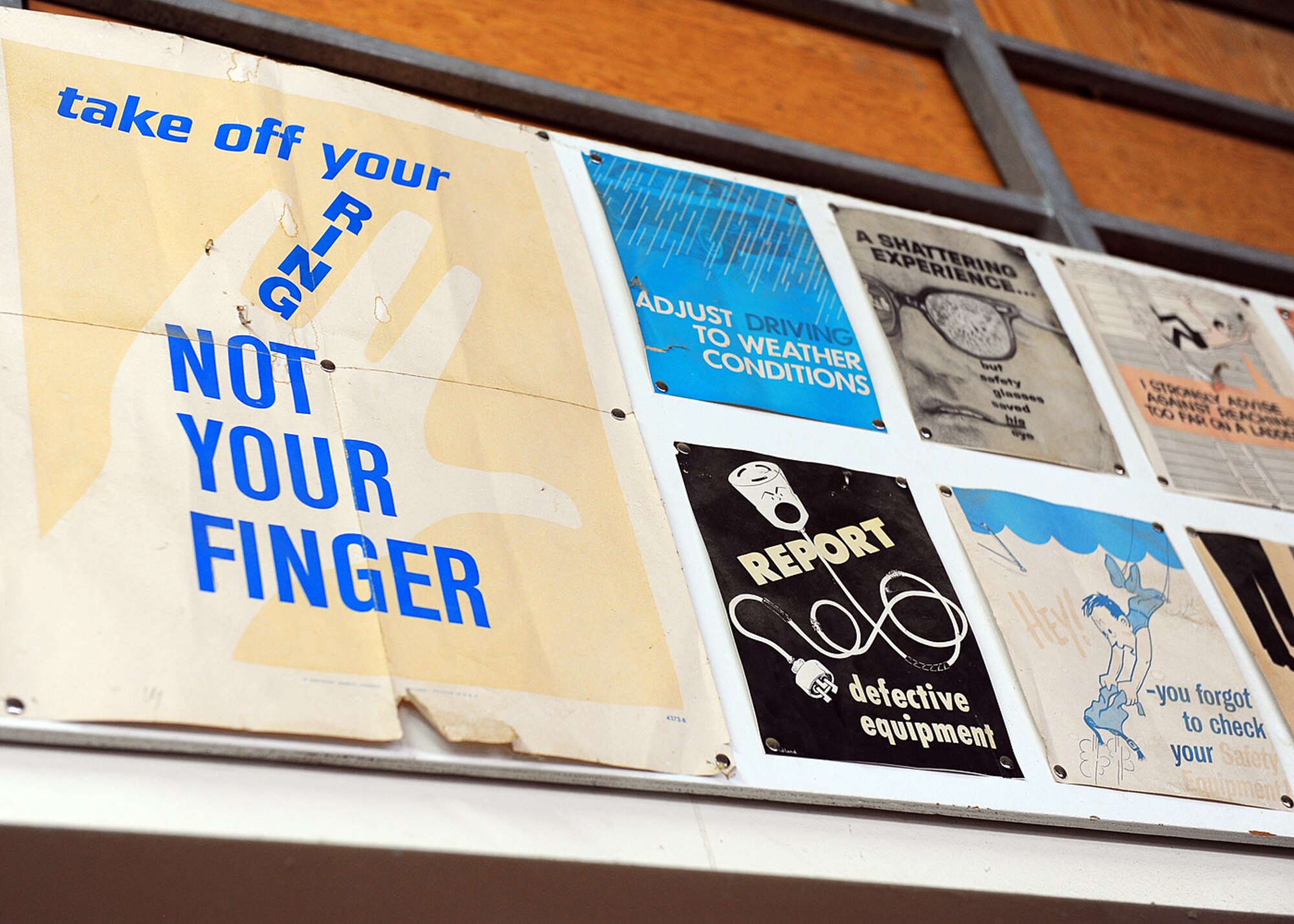 SPANGDAHLEM AIR BASE, Germany – The 52nd Civil Engineer Squadron Housing Supply Warehouse staff collects safety posters along the front of one of their maintenance rooms. Some of the posters date back to the late ‘80s, which is when Walter Mueller, 52nd CES HSW storekeeper, began working there. (U.S. Air Force photo by Staff Sgt. Daryl Knee/Released)