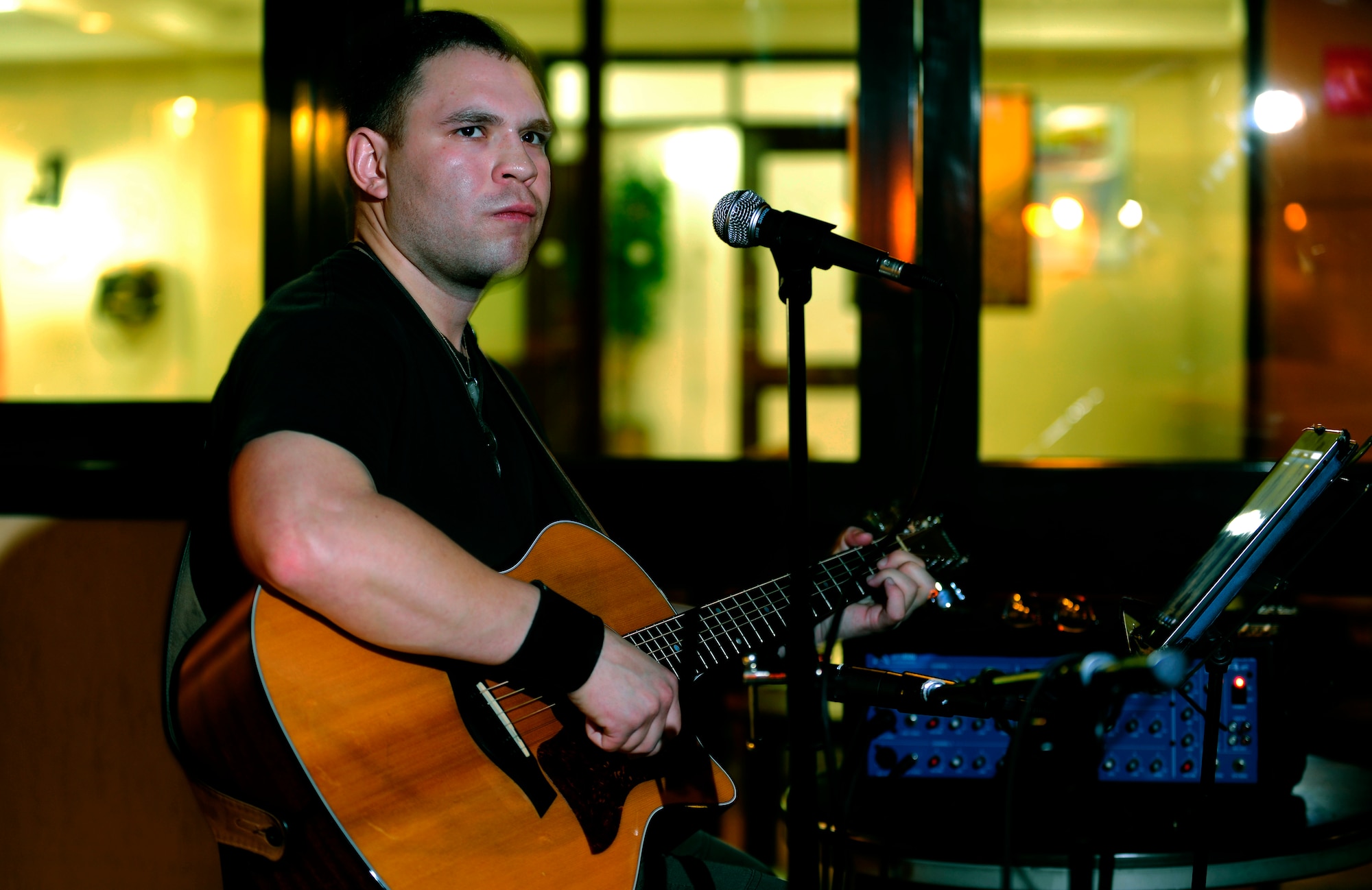 Staff Sgt. Christian Maes, 39th Medical Operations Squadron medical technician, finishes a song during open mic night Aug. 6, 2013, at Incirlik Air Base, Turkey. Every Tuesday open mic night is held outside the Incirlik club complex and is open to all Team Incirlik members to showcase their talents. (U.S. Air Force photo by Senior Airman Daniel Phelps/Released)