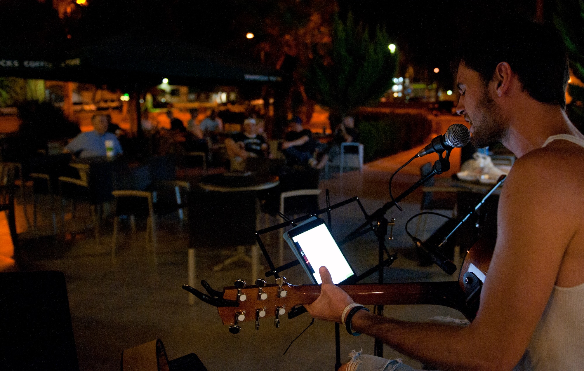 James Miller sings to an audience at open mic night Aug. 6, 2013, at Incirlik Air Base, Turkey. Open mic night occurs Tuesday nights outside of the Incirlik club complex. (U.S Air Force photo by Senior Airman Daniel Phelps/Released)