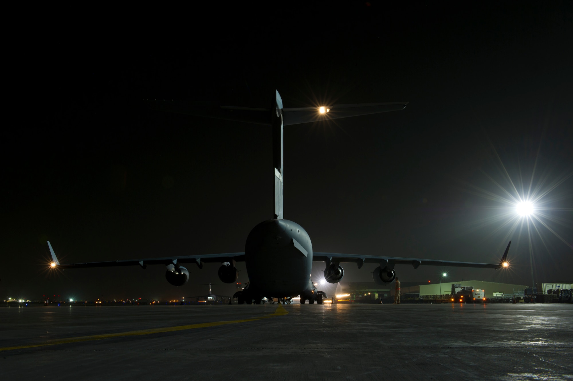 A C-17 Globemaster III sits parked on the flight line after downloading vehicles and supplies during an airlift mission, July 26, 2013, Kandahar Air Field, Afghanistan. The C-17 is capable of rapid strategic and tactical delivery of troops and any type of cargo around the Central Command area of reasonability. The aircraft can perform airlift, airdrop, and transport ambulatory patients during aeromedical evacuations when required. The C-17 is deployed from Travis Air Force Base, Calif. (U.S. Air Force photo/Staff Sgt. Marleah Miller)