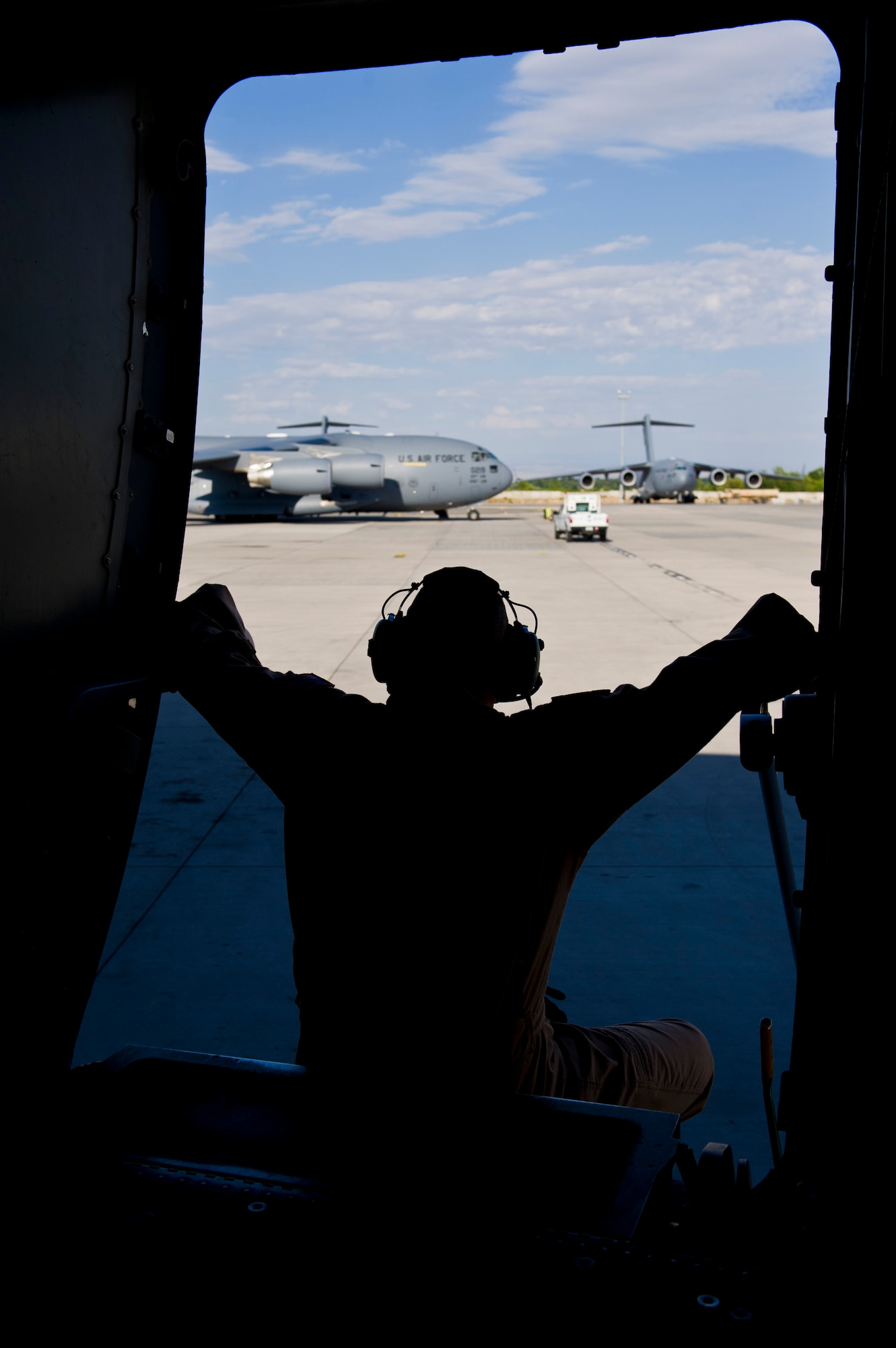 U.S. Tech. Sgt. Gary Washington, 316th Expeditionary Airlift Squadron C-17 Globemaster III loadmaster, waits to take-off after completing pre-flight checklists before an airlift mission, July 26, 2013,  Manas Air Base, Kyrgyzstan. The C-17 is capable of rapid strategic and tactical delivery of troops and any type of cargo around the Central Command area of reasonability. The aircraft can perform airlift, airdrop, and transport ambulatory patients during aeromedical evacuations when required. (U.S. Air Force photo/Staff Sgt. Marleah Miller)