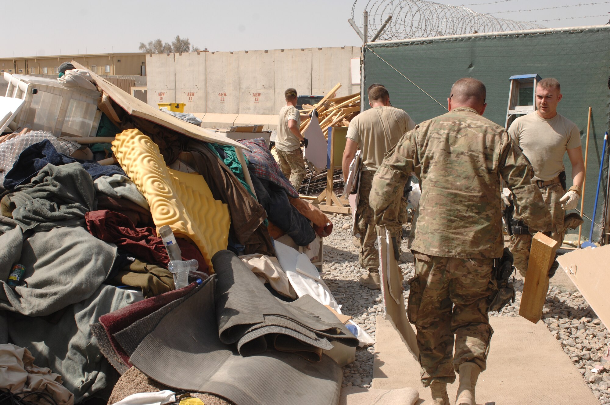 Airmen from the 451st Air Expeditionary Wing tear down and clean out a tent at Camp Samek, Kandahar Airfield, Afghanistan, Aug. 22, 2013. Several 451st Expeditionary Logistics Readiness Squadron functions are consolidating onto Samek, reducing the footprint of the 451st AEW at KAF. (U.S. Air Force photo by Senior Airman Jack Sanders)