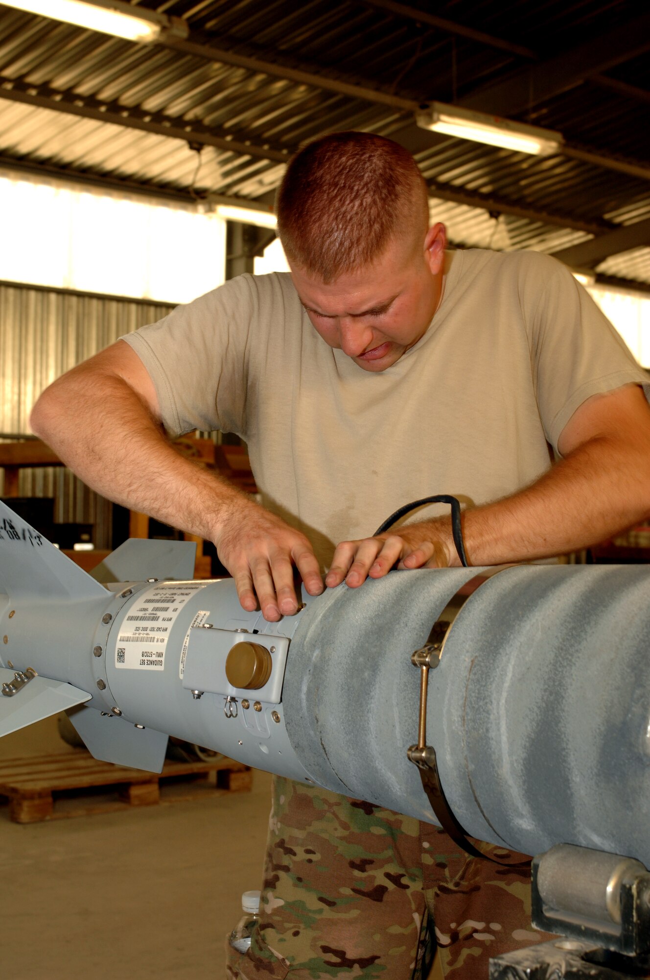 Airman 1st Class Joseph Stoffer 451st Expeditionary Maintenance Squadron munitions crewmember attaches the guidance tail to a Guided Bomb Unit-54 at Kandahar Airfield, Afghanistan Aug. 16, 2013. Proper placement and positioning of every component is necessary to ensure the weapon works as designed. Stoffer is deployed from Spangdahlem Air Base, Germany , and is a native of Warsaw, N.Y. (U.S. Air Force photo/Senior Airman Jack Sanders)