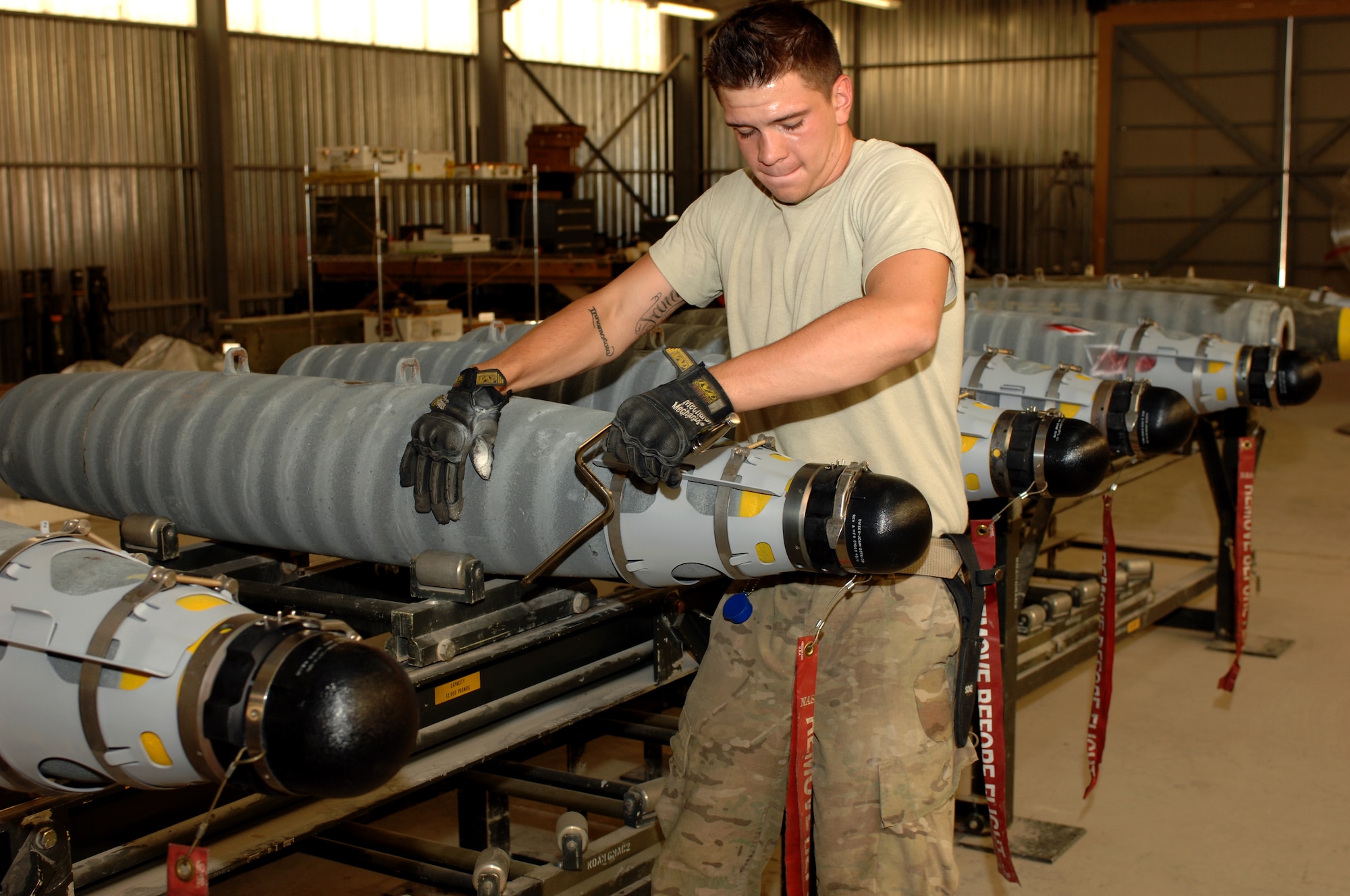 Airman 1st Class Ty Cole, 451st Expeditionary Maintenance Squadron munitions crewmember carefully moves a Guided Bomb Unit-54 being built for aircraft at Kandahar Airfield, Afghanistan, Aug. 16, 2013. Munitions Airmen are required to handle all equipment with care due to the sensitive nature of their job. Cole is deployed from Spangdahlem Air Base, Germany, and is a native of Danbury, Conn. (U.S. Air Force photo by Senior Airman Jack Sanders)