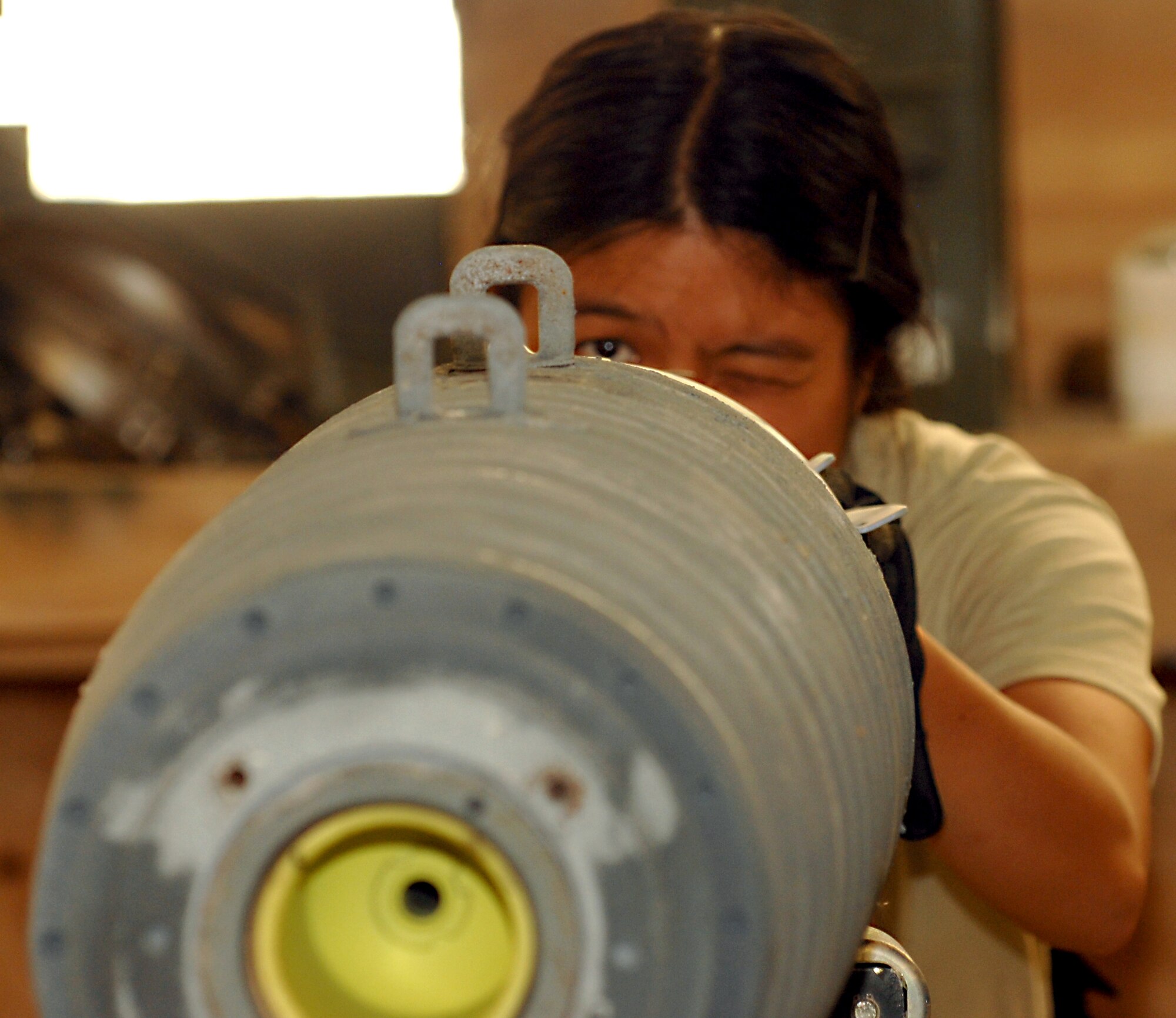 Airman 1st Class Pamela Wu, 451st Expeditionary Maintenance Squadron, munitions crewmember checks the alignment of parts on the Guided Bomb Unit-54 (GBU-54) munitions being built for aircraft at Kandahar Airfield, Afghanistan, Aug. 16, 2013. Intricate pieces of the GBU-54 require that all parts of the munitions line up to fit together correctly. Wu is deployed from Spangdahlem Air Base, Germany, and is a native of Heywood, Calif. (U.S. Air Force photo by Senior Airman Jack Sanders)
