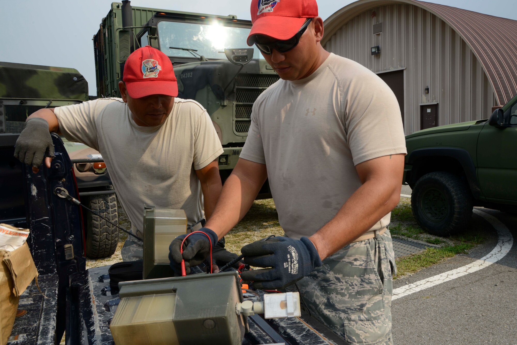 (Left to right) U.S. Air Force Staff Sgt. Edward Quichocho and Master Sgt. Tommy Joe Rivera, 254th  RED HORSE Squadron electricians, calibrate an exterior flooding light at Rush Park, Osan Air Base, Republic of Korea, during the Ulchi Freedom Guardian 2013 exercise, Aug. 18, 2013. The RHS provide highly mobile civil engineering response force to support contingency and special operations worldwide. UFG is a realistic training event focused on preparing, preventing and prevailing against the full range of current and future threats to the ROK and the region. (U.S. Air Force photo/Staff Sgt. Sheila deVera)