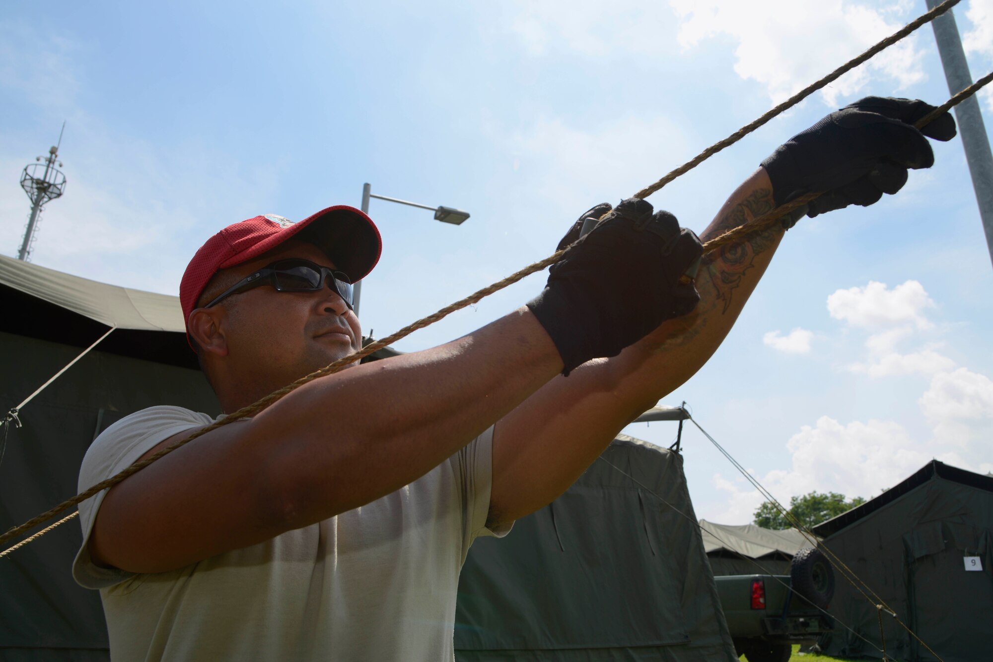 U.S. Air Force Senior Airman Michael Morales, 254th RED HORSE Squadron structure journeyman, secures a TEMPER (tent extendable modular personnel) tent at Rush Park, Osan Air Base, Republic of Korea, during the Ulchi Freedom Guardian 2013 exercise, Aug. 18, 2013. The 254th RHS has been preparing and supporting the UFG since 2006 standing up a tent city for the exercise participants. UFG is an annual training event designed to ensure readiness to defend the ROK and sustain the capabilities that strengthen the ROK-U.S. Alliance. (U.S. Air Force photo/Staff Sgt. Sheila deVera)
