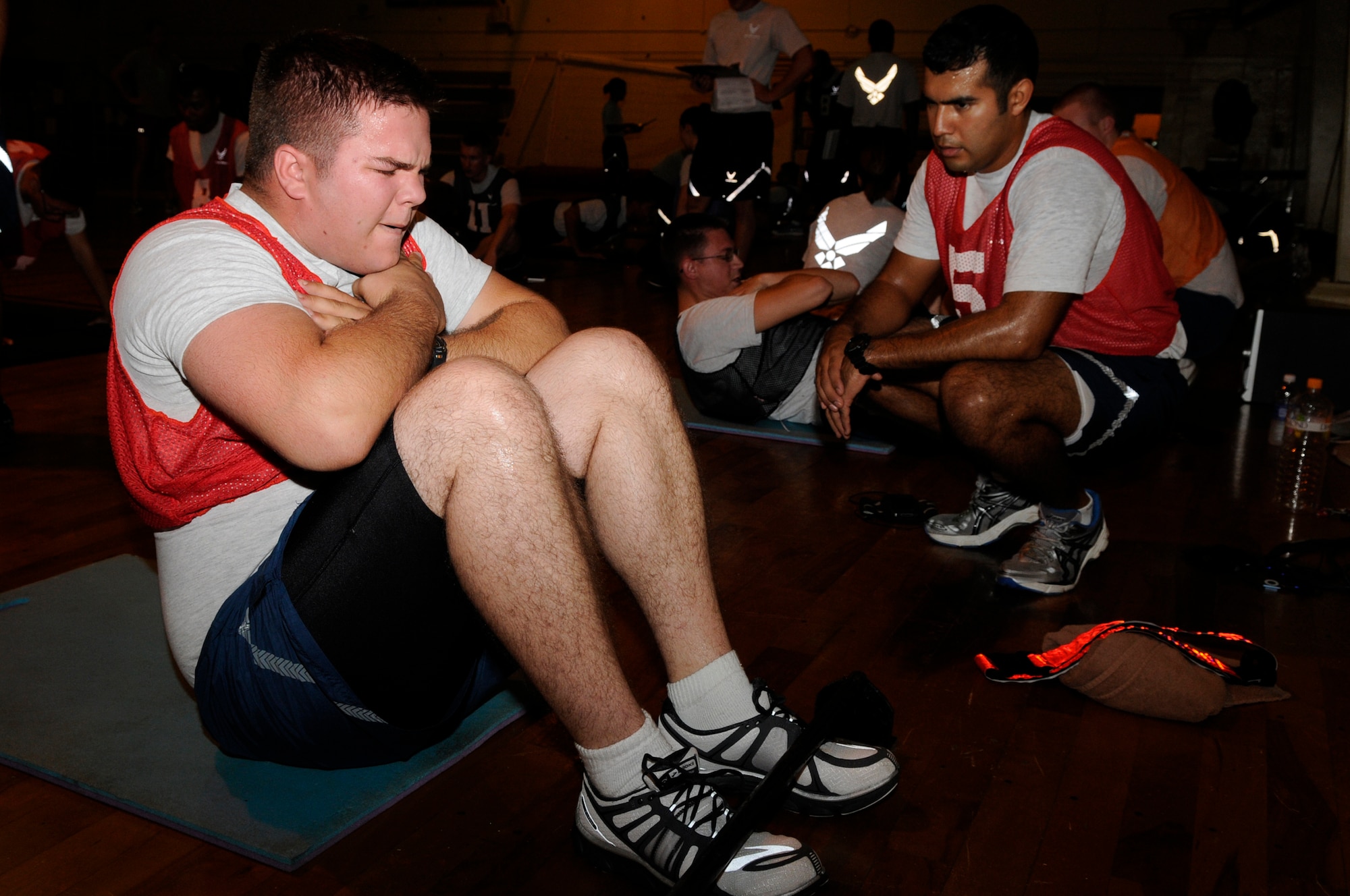 U.S. Air Force Airman 1st Class Daniel Opp, 18th Aircraft Maintenance Squadron, performs the sit-up portion of the physical fitness assessment test on Kadena Air Base, Japan, Aug. 27, 2013. Airmen must reach the minimum score on each of the four components to pass the physical training test. (U.S. Air Force photo by Senior Airman Marcus Morris)