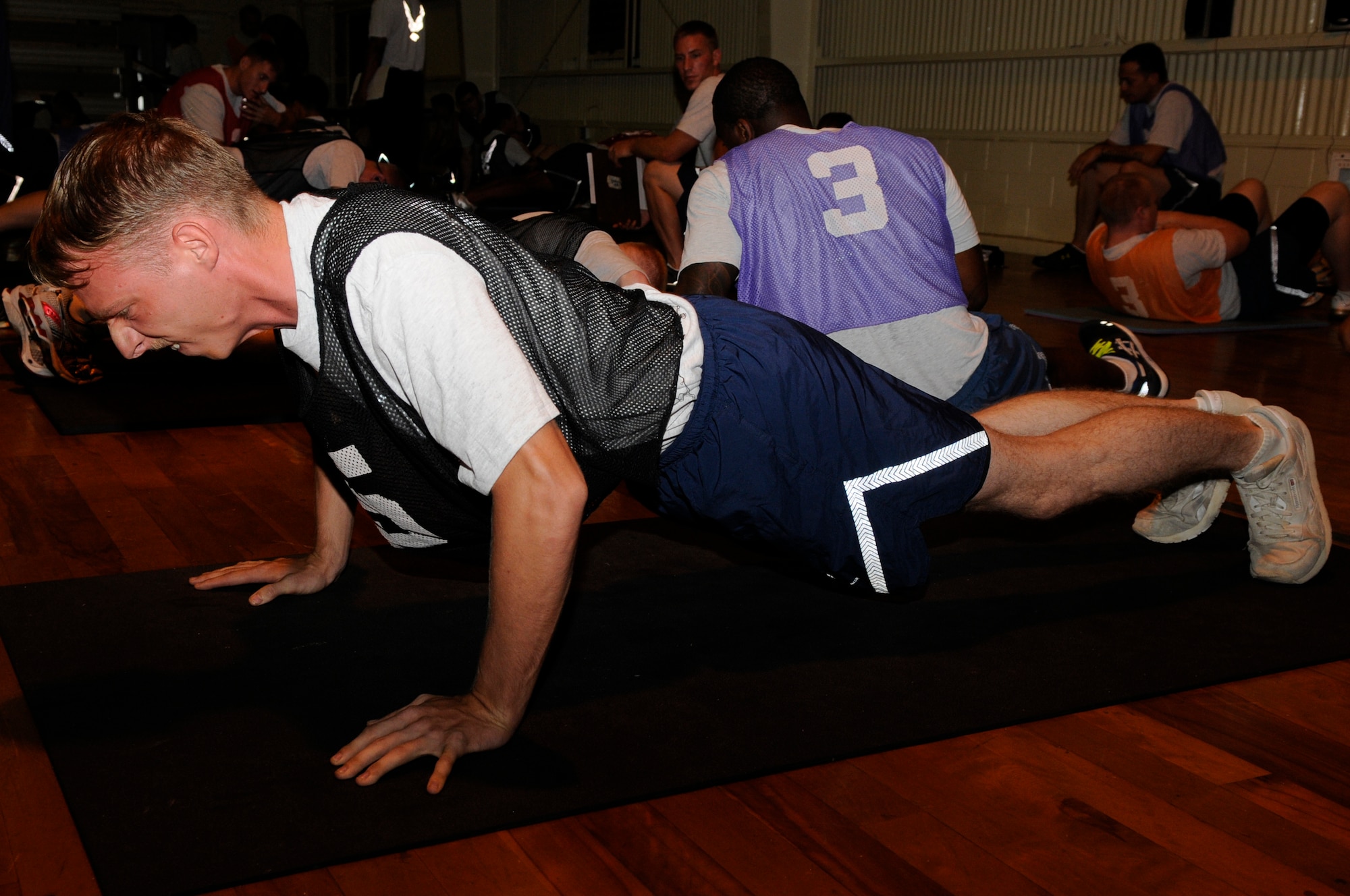 U.S. Air Force Senior Airman Peter Iriarte, 18th Aircraft Maintenance Squadron avionics specialist, performs the push-up portion of the physical fitness assessment test on Kadena Air Base, Japan, Aug. 27, 2013. Starting Sept. 1, Airmen on Kadena AB will be required to join a Be Well Program if they fail their physical training test. (U.S. Air Force photo by Senior Airman Marcus Morris)