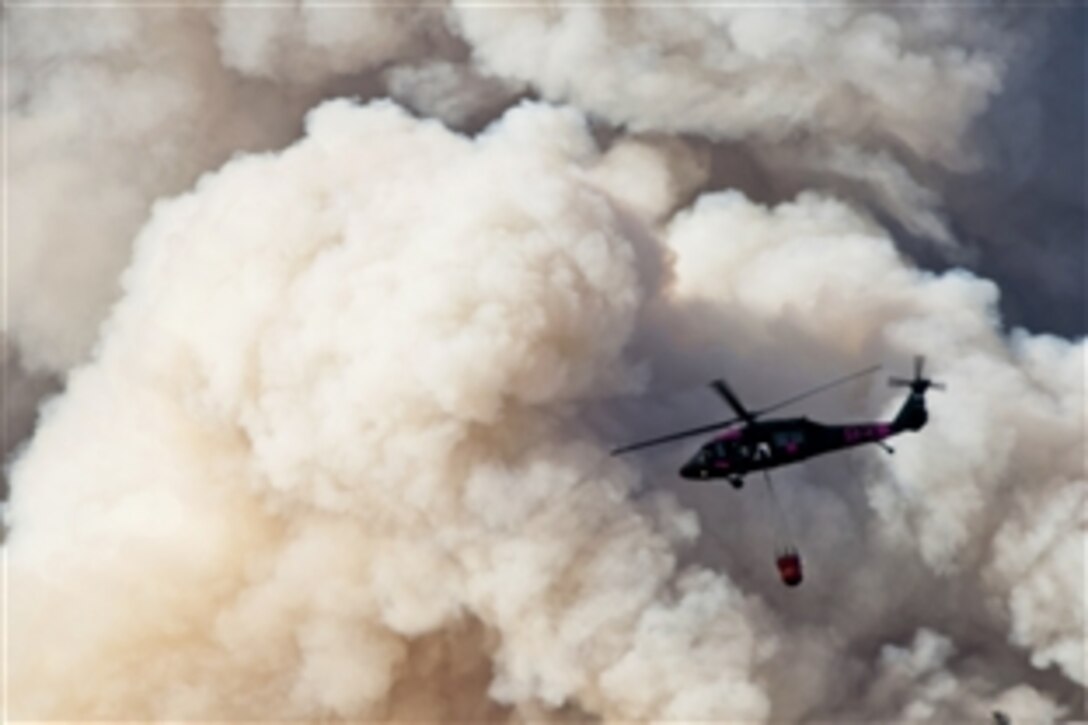 Army Chief Warrant Officer Chris Aylstock, Capt. Colton Brauer and Sgt. Chris Boni battle the wildfire over Yosemite National Park, Calif., Aug. 22, 2013. The California National Guard UH-60 Black Hawks and HH-60 Pave Hawks are in full force supporting the U.S. Forest Service and California firefighters. Aylstock, Brauer and Boni are assigned to 1st Battalion, 140th Aviation Regiment.